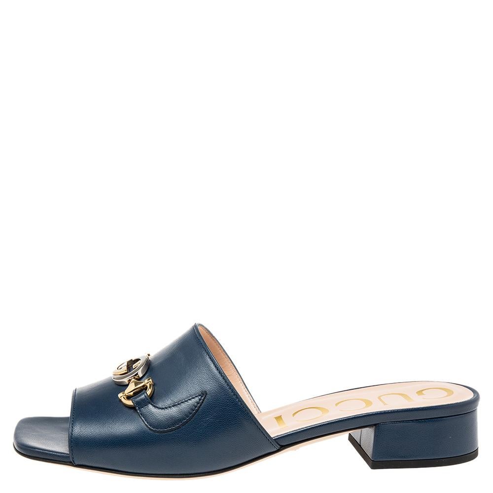 Be it casual or formal outings, these Gucci slides will add the right amount of elegance and poise to your ensemble. They are crafted from navy blue leather into a sleek silhouette and feature broad vamp straps augmented by a unique combination of
