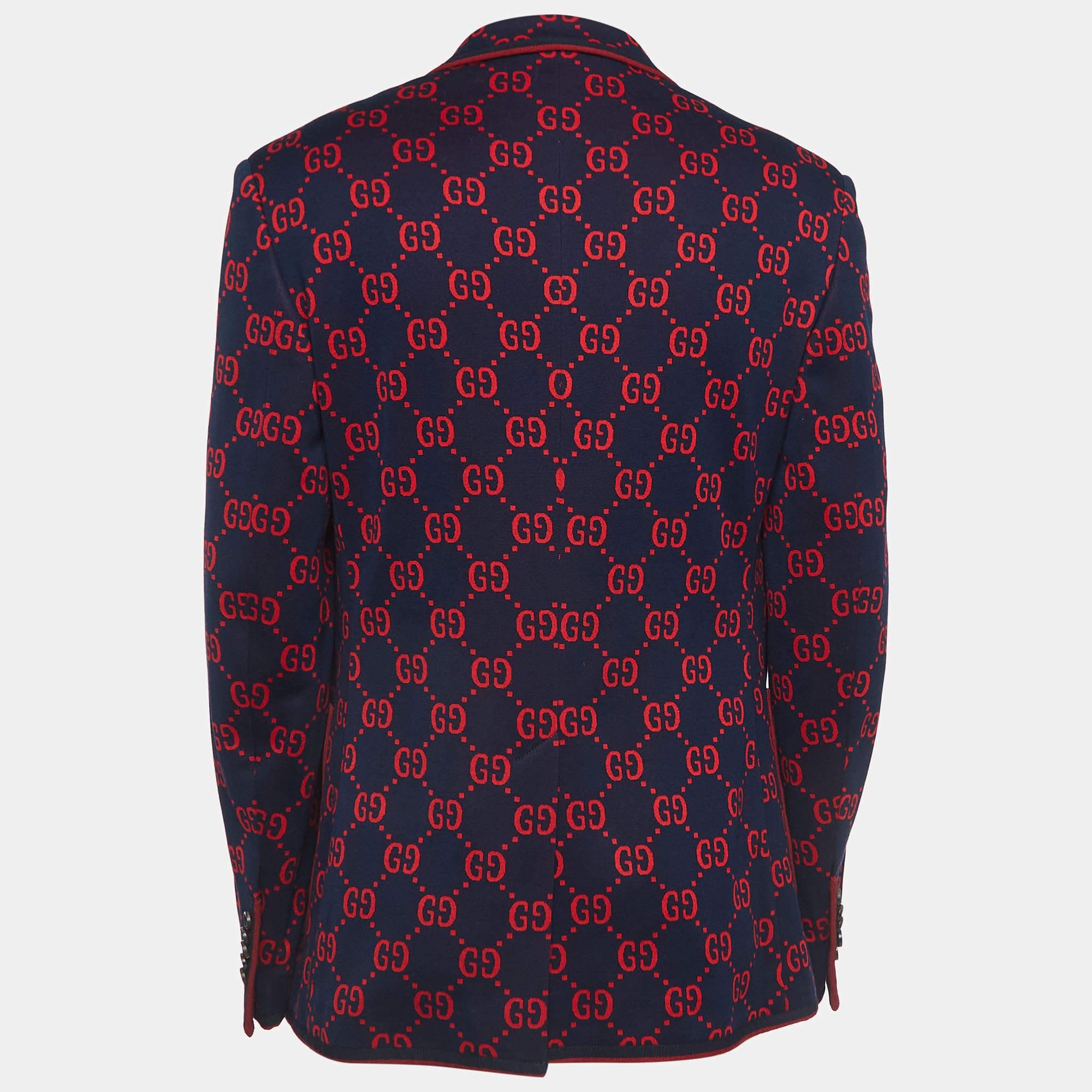 The Gucci blazer exudes timeless elegance and sophistication. Crafted with meticulous attention to detail, its rich navy blue hue is complemented by striking red jacquard accents, adding a touch of opulence. This versatile piece seamlessly combines
