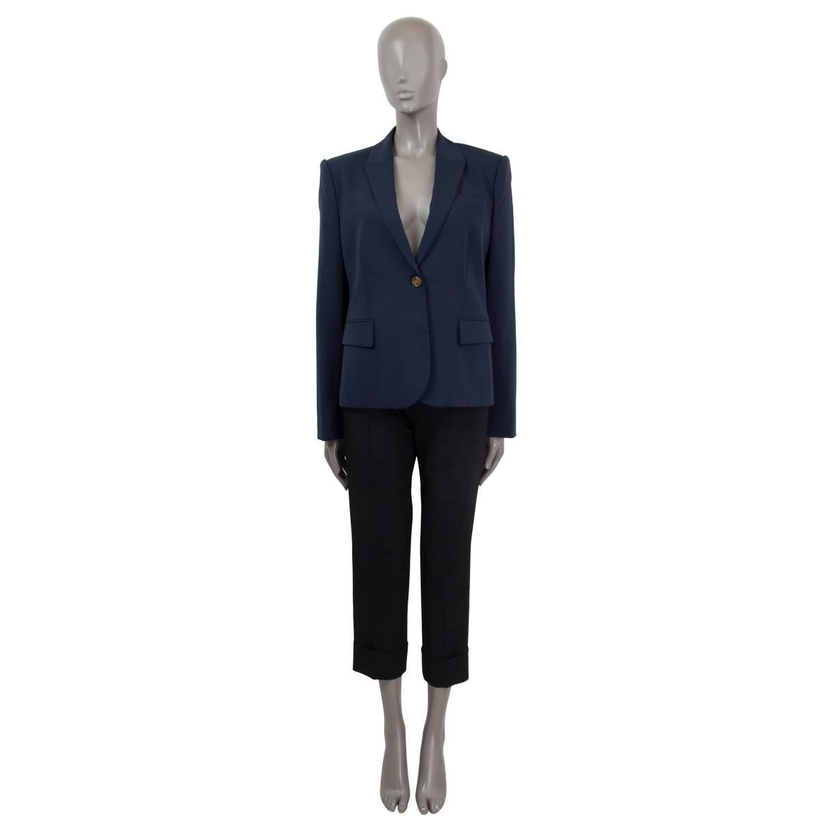 100% authentic Gucci long sleeve blazer in navy wool (97%) and elastane (3%). Features buttoned cuffs and two flap pockets on the front. Opens with one 'GG' button on the front. Lined in black viscose (75%) and polyester (25%). Has been worn and is
