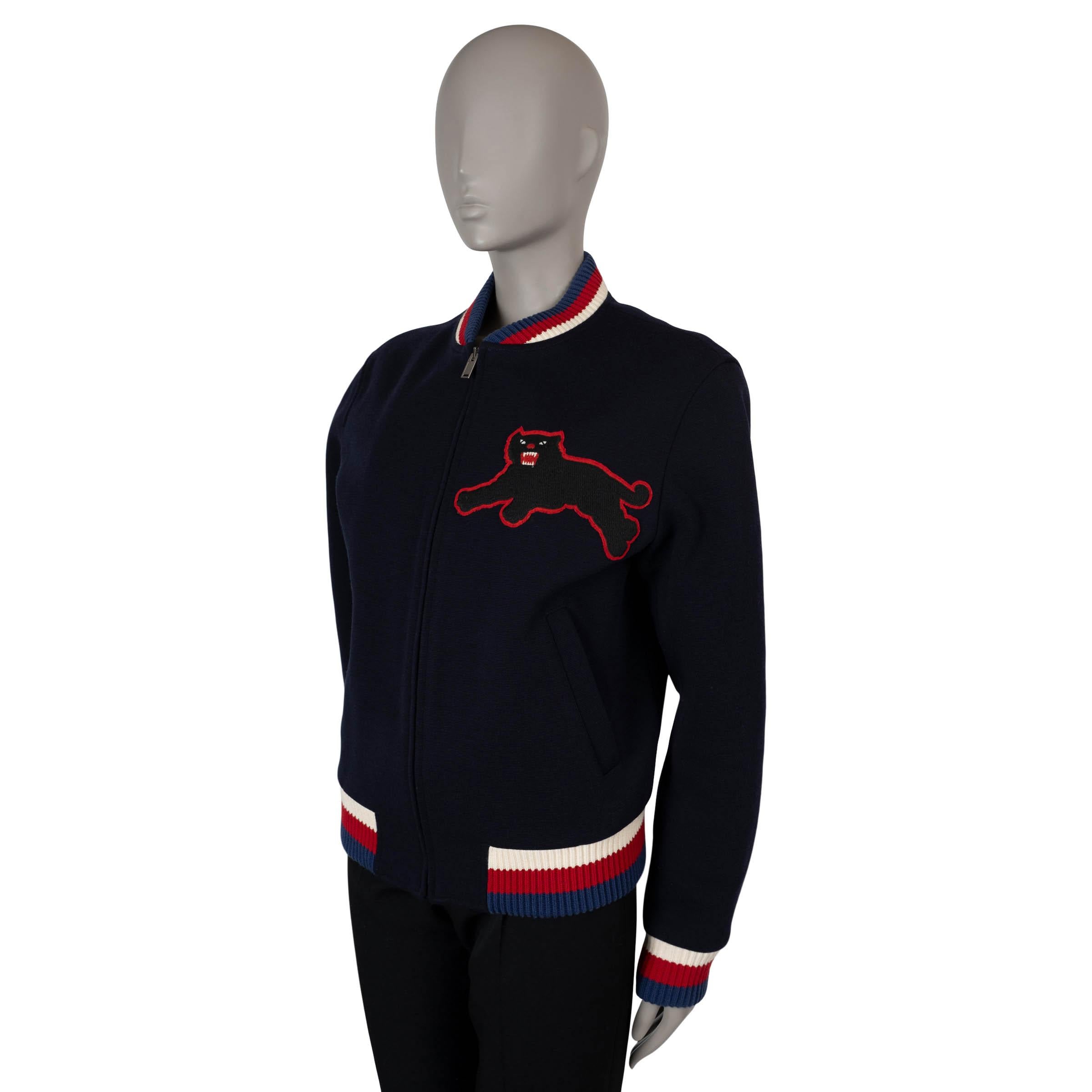 This 100% authentic Gucci by Alessandro Michele bomber jacket is crafted from navy blue jersey wool (80%) and polyamide (20%). It features a black embroidered panther appliqué on the chest and Sylvie web rib-knit trims in red, white, and blue. The