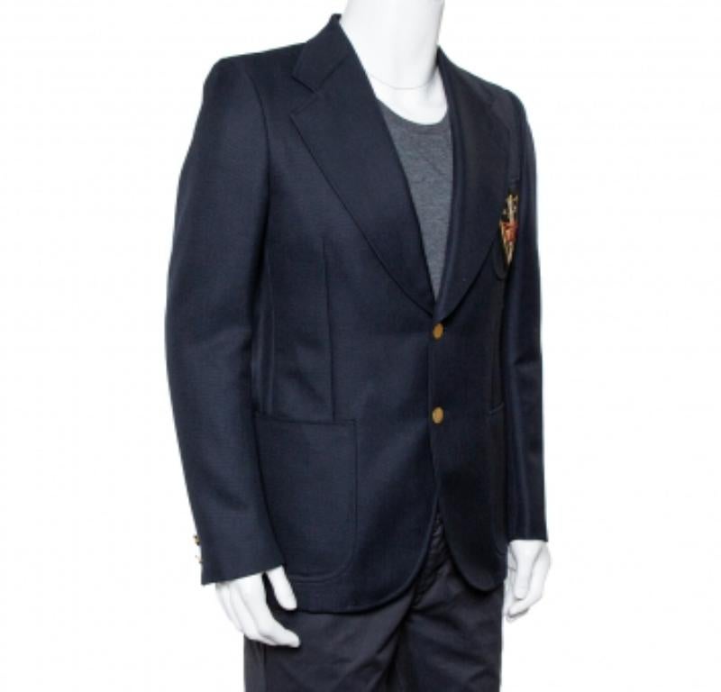 You are sure to make a statement with this blazer! This navy blue Gucci creation is made of mohair and wool and designed with notched lapels. It flaunts front button fastenings, an embroidered patch detailing on the chest, and 'Chateau Marmont