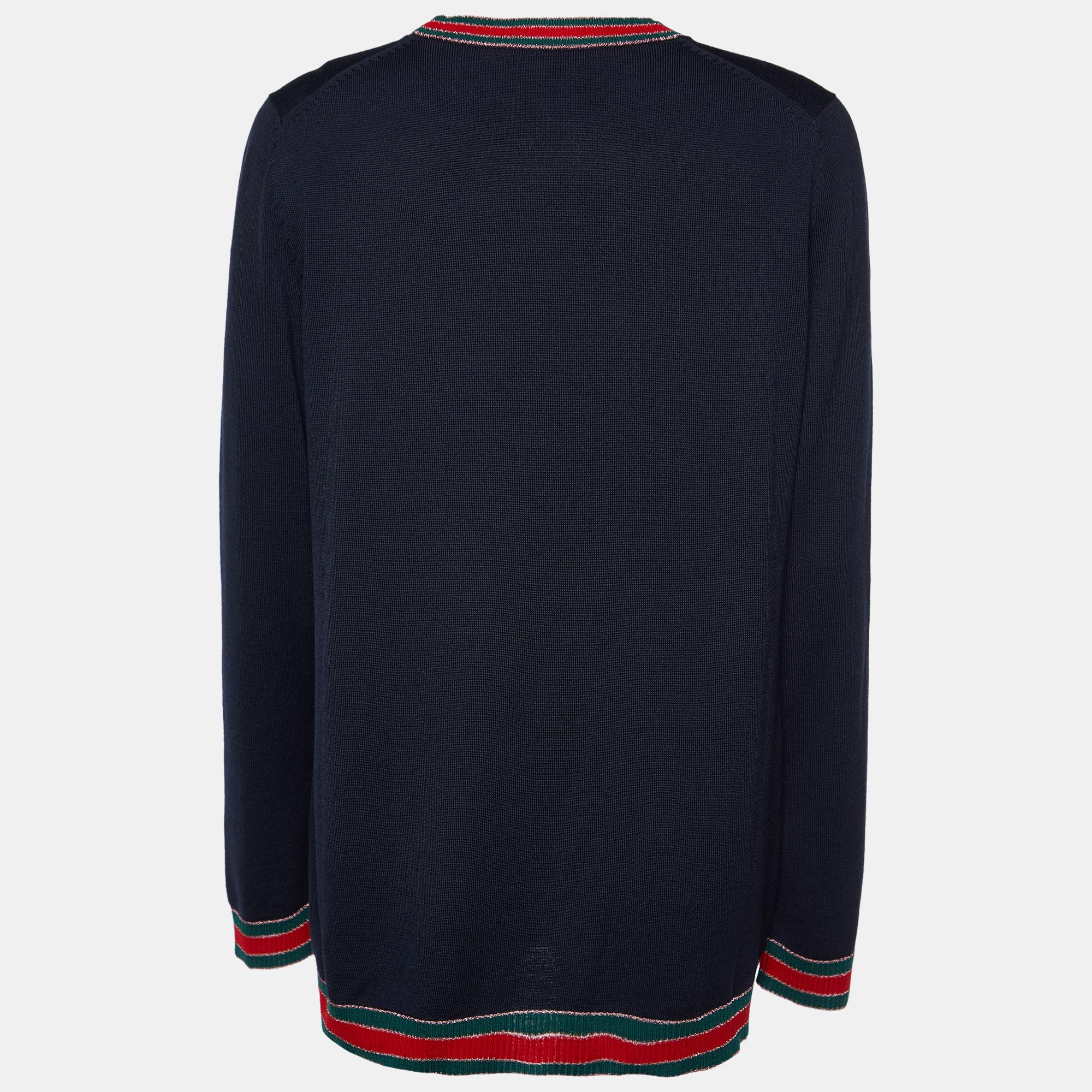 Wrap yourself in the understated luxury of the Gucci cardigan. Crafted with precision from fine wool, this cardigan features a sleek button-front design accentuated by the iconic Gucci web trim. Effortlessly stylish, it exudes timeless charm and