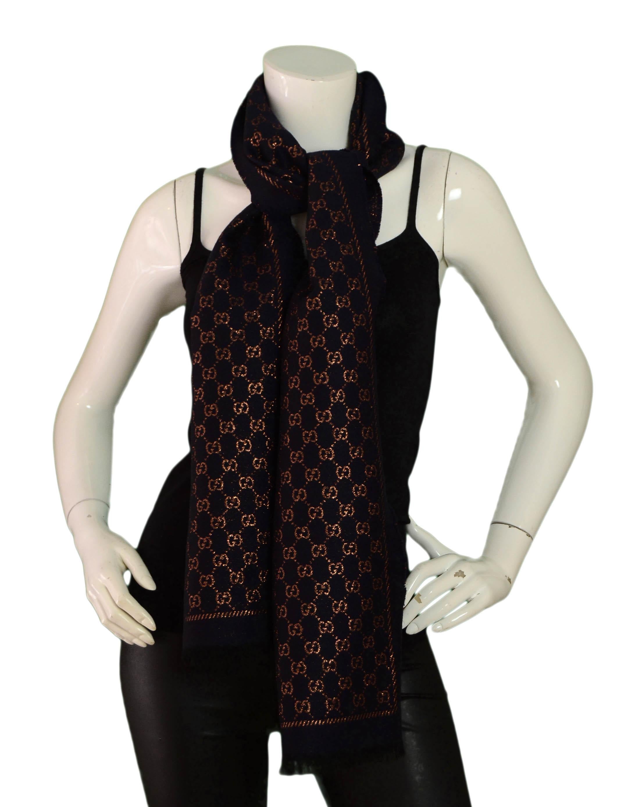 Gucci Navy/Bronze Metallic Monogram GG Wool Scarf

Made In: Italy
Color: Navy with metallic bronze
Materials: 84% wool, 7% silk, 5% metallised fiber
Overall Condition: Excellent pre-owned condition
Estimated Retail: $350 plus tac
Includes: Gucci