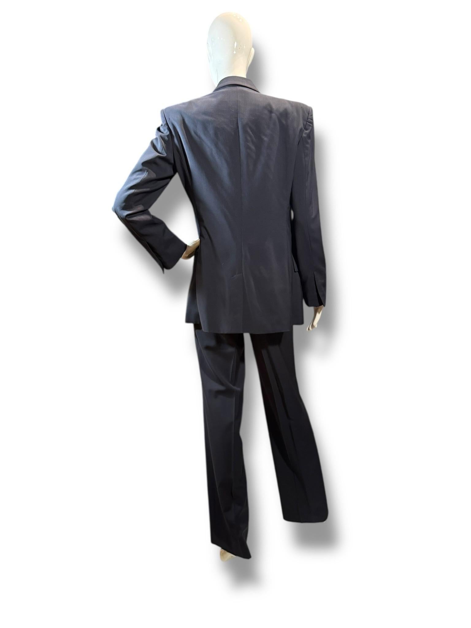 An ultra-rare and razor-sharp ensemble from the Tom Ford era at Gucci, this 1990s three-piece power suit captures the refined sensuality and tailored dominance Ford became known for. Cut in deep navy wool, the set includes a structured