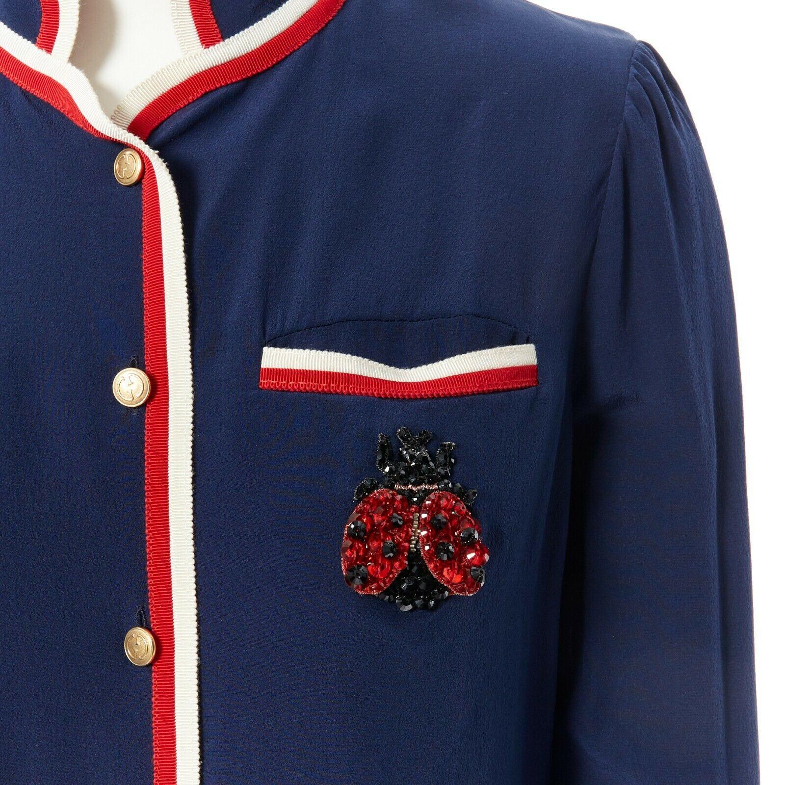 GUCCI navy tricolour ladybird ladybug embellish brooch badge silk shirt IT36 XXS 
Reference: LNKO/A01100 
Brand: Gucci 
Material: Silk 
Color: Blue 
Pattern: Other 
Closure: Button 
Extra Detail: Navy uniform inspired. Embellished ladybird badge