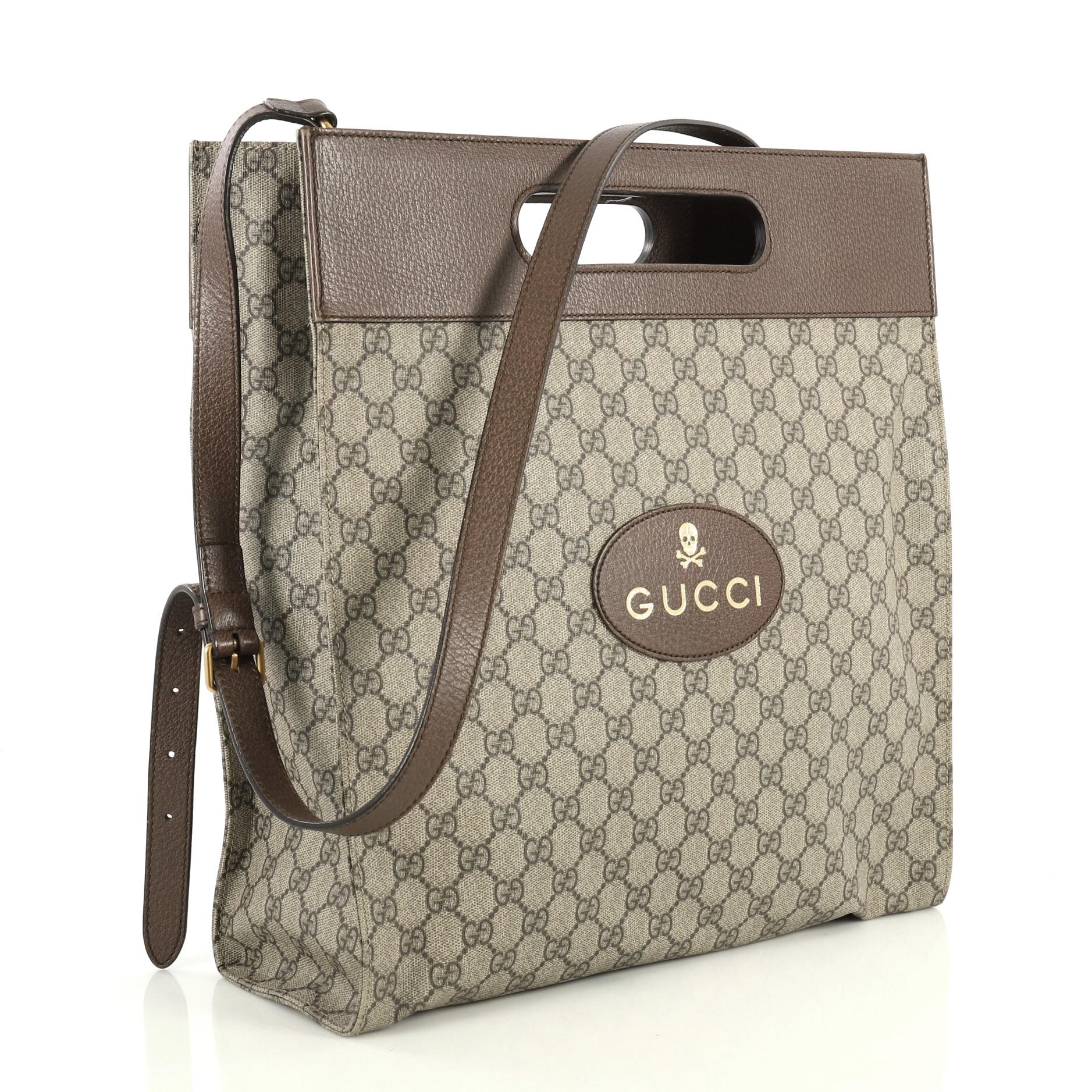 This Gucci Neo Vintage Soft Tote GG Coated Canvas Medium, crafted from brown GG coated canvas, features cut out top handles and aged gold-tone hardware. It opens to a neutral fabric interior with side zip pocket. 

Estimated Retail Price: