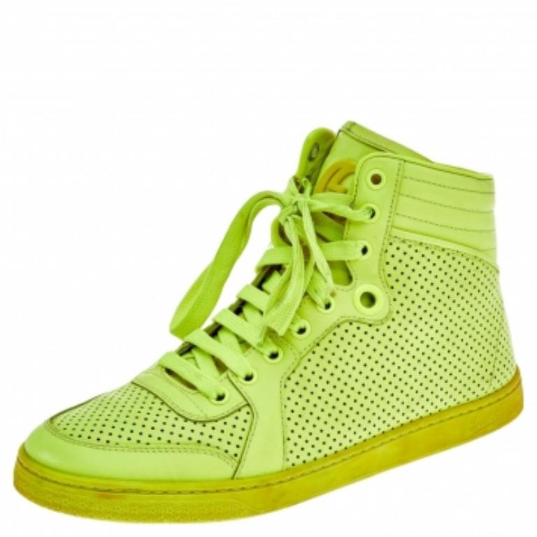 An eye-catchy and trendy pair as this one is sure to fetch you praise and attention. This pair of sneakers from the House of Gucci is created using neon green perforated leather and flaunts a lace-up feature, high-top profile, and matching hardware.