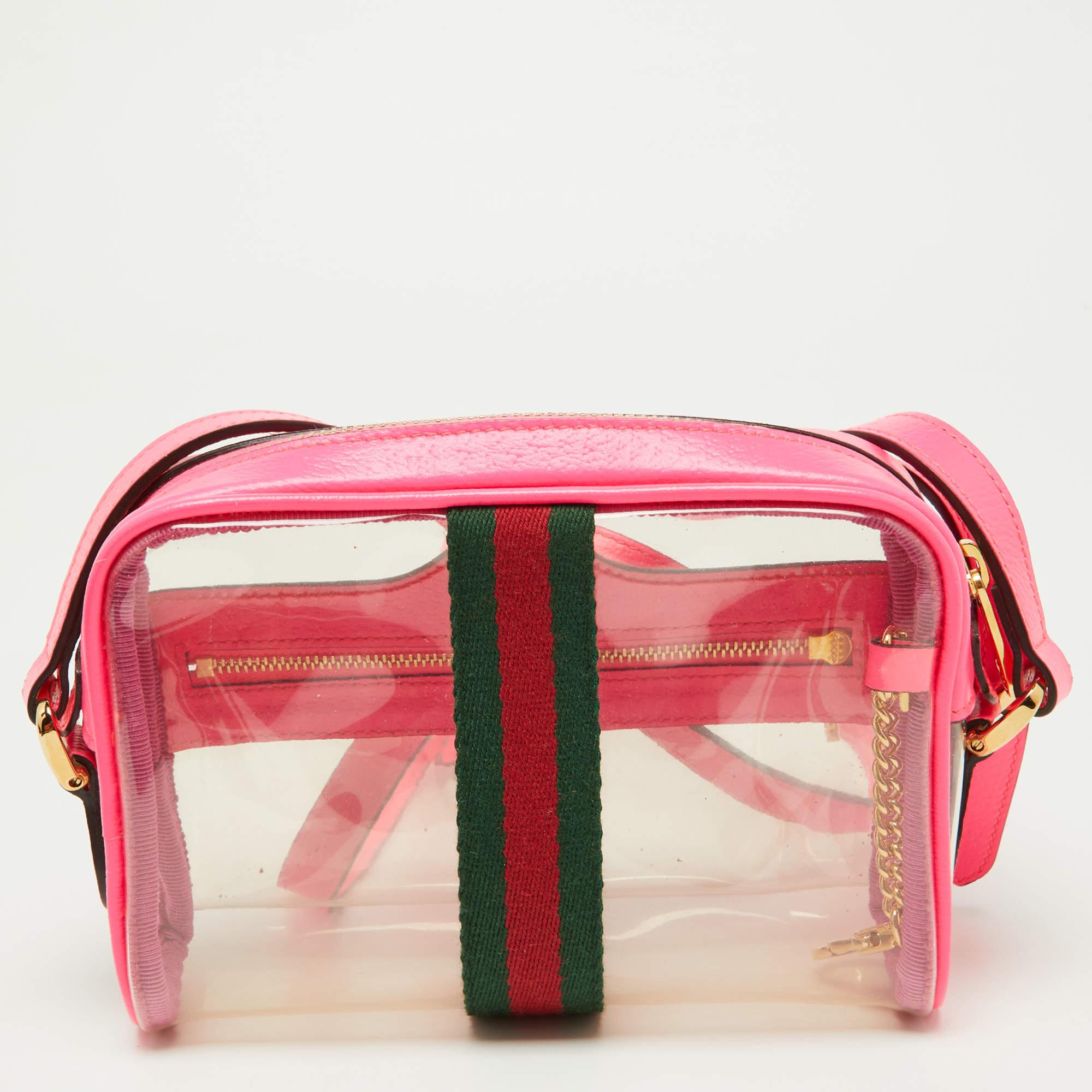The Gucci Ophidia crossbody bag is a compact yet stylish accessory. It comes in PVC and neon pink leather, and a long strap for versatile wear. This bag effortlessly blends luxury and fashion-forward design.

