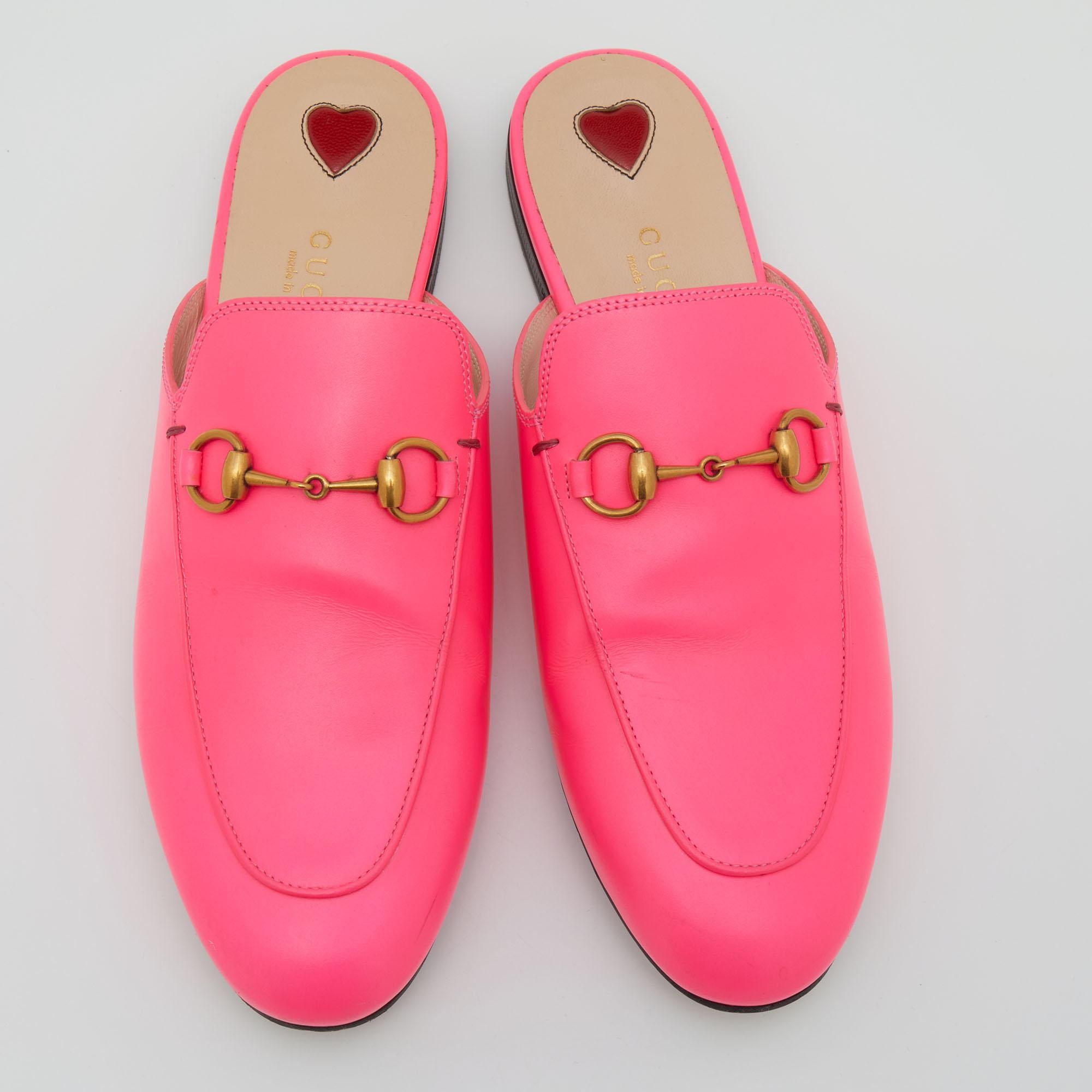 These Gucci Princetown mules are a fresh summer pair. These shoes are enhanced by brass-tone Horsebit details that have defined the brand since the very beginning. Featuring a bright neon pink, leather exterior, they are the epitome of modern