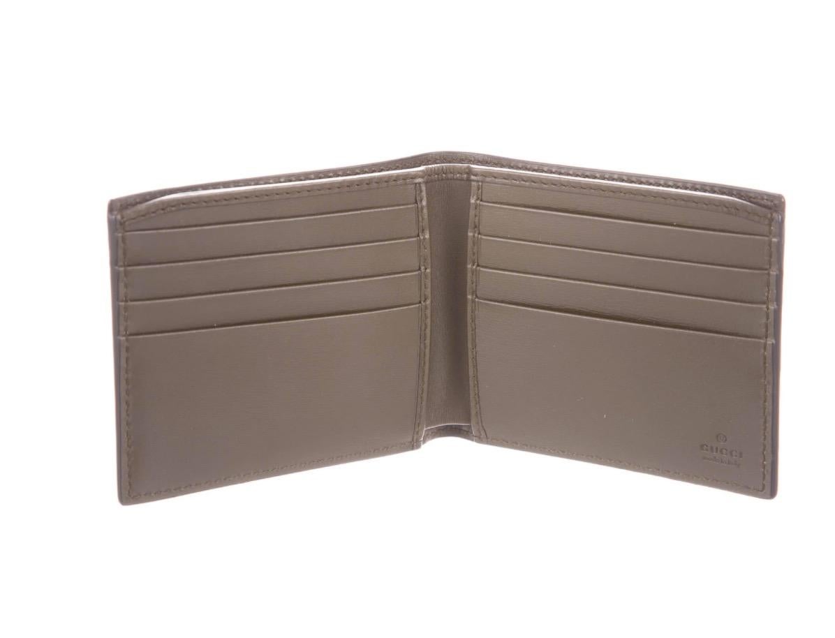 Crocodile 
Leather lining
Features dual bill compartments and eight card slots 
Measures 4.25