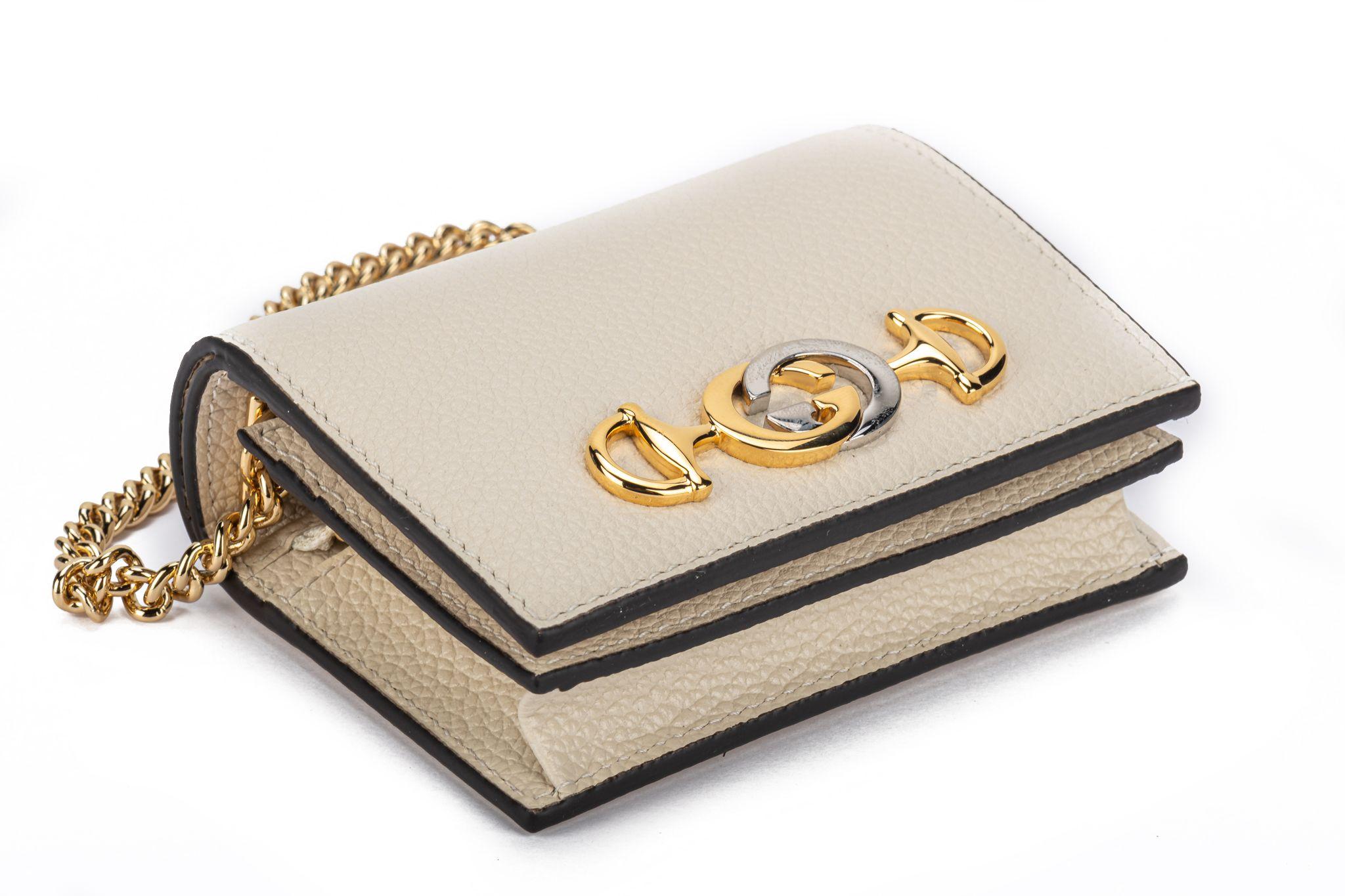 Gucci new mini bag/wallet with detachable chain. Cream pebbled leather and gold tone hardware. Handle drop 4”. Comes with original dust cover and box.
