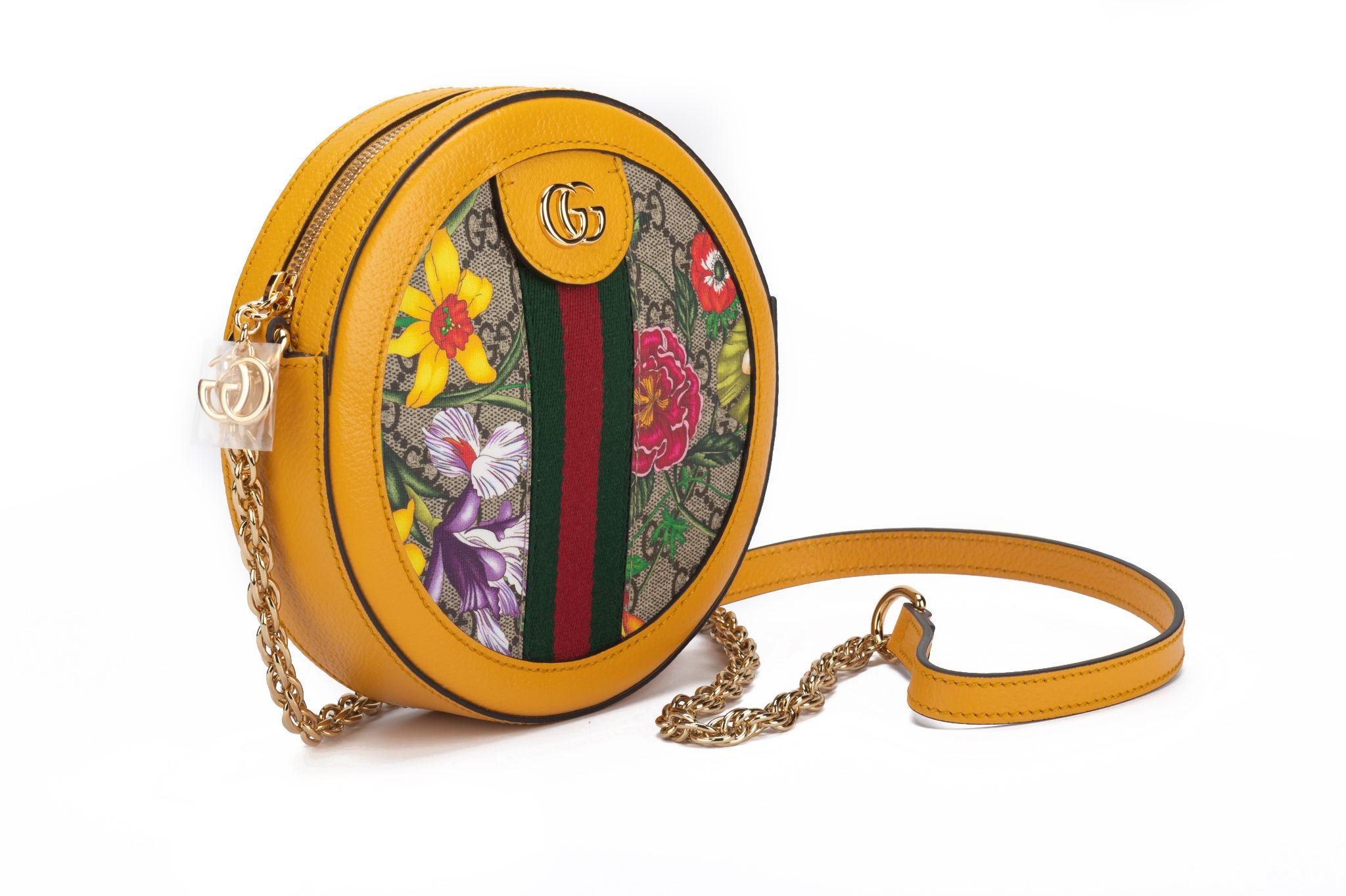 Gucci brand new flora coated canvas round bag with soleil yellow leather trim. Detachable shoulder strap 22.5”, can be worn cross body. Comes with booklet and original dust cover.