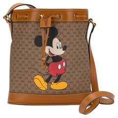 Shop the Disney x Gucci round shoulder bag in beige at GUCCI.COM