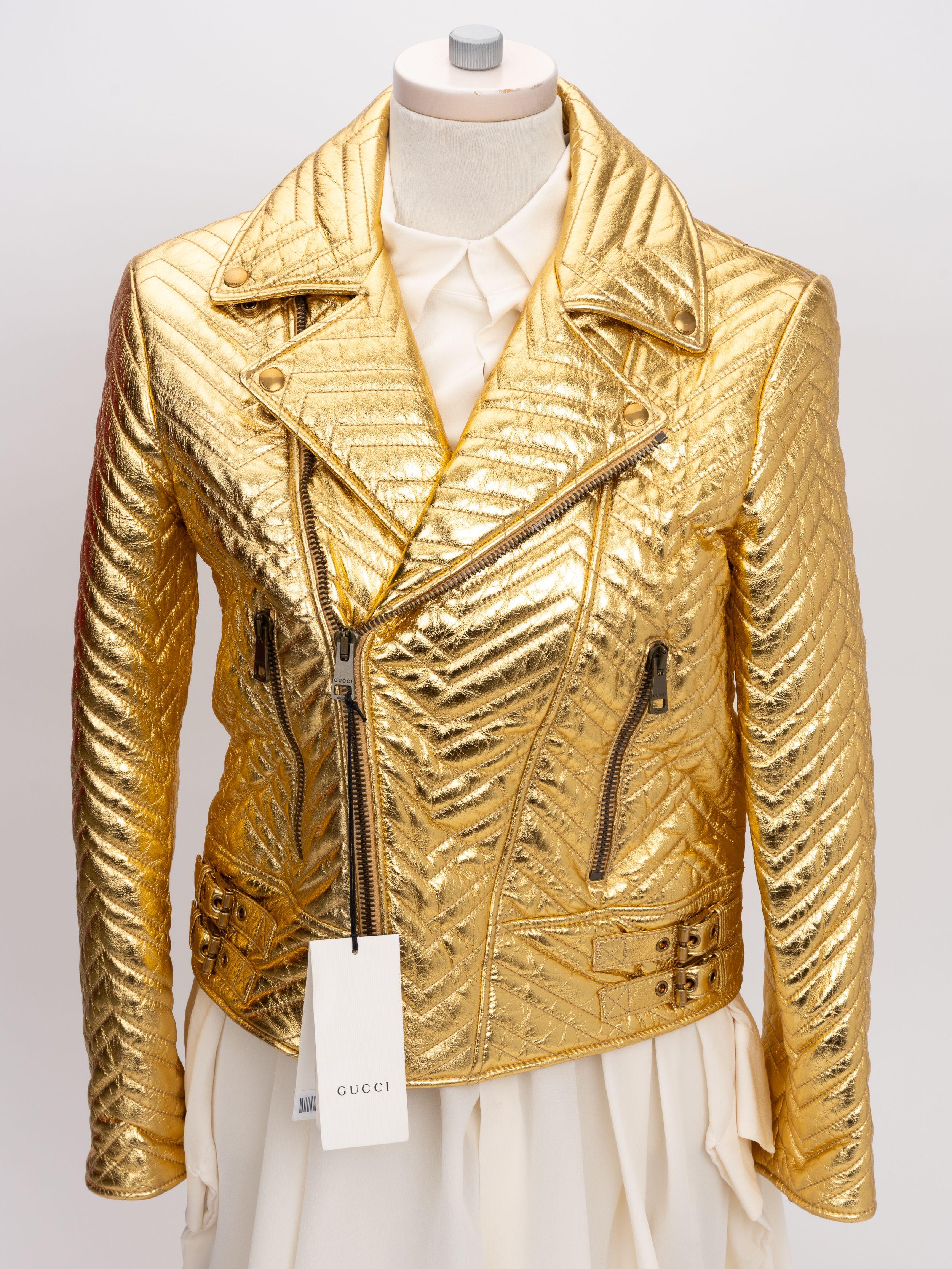 Gucci biker jacket made from soft leather and gold metallic color. Zipper front with two zipper pockets. Signature Marmont heart in the back. 
Size italian 40, small. 
Measurements: Shoulders 17.5