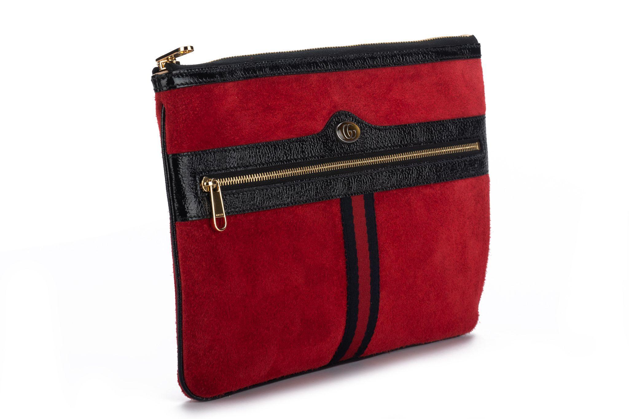 Gucci brand new red suede and black patent leather clutch with gold hardware. Outer zipped pocket and top zipper. Comes with original dust cover.