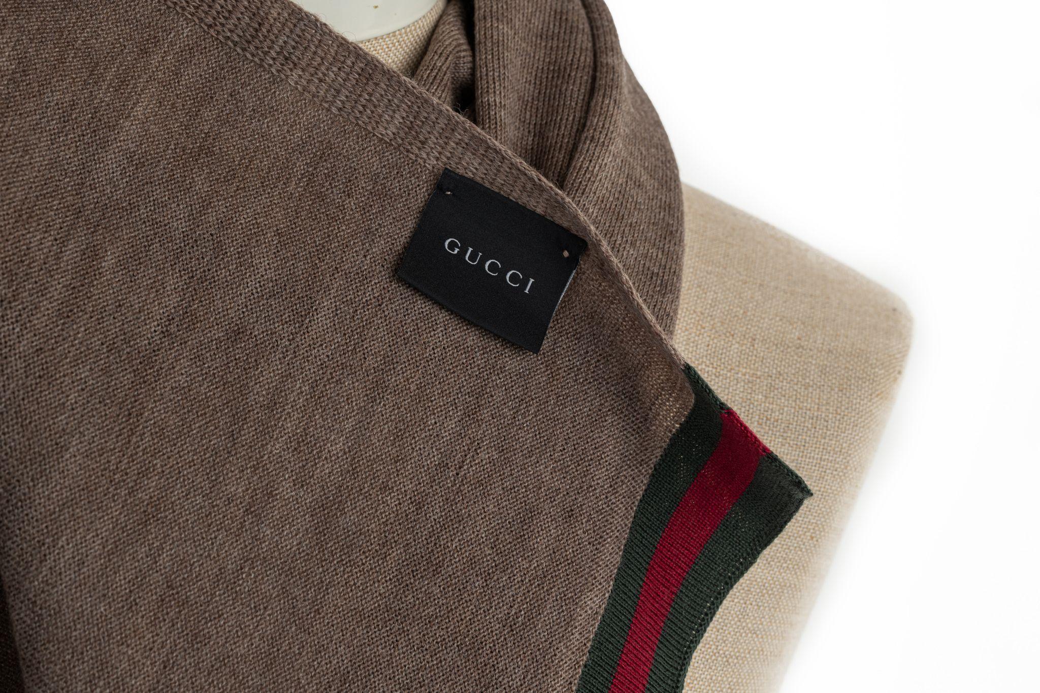 Gucci brown wool shawl. The ends of the item are colored in the traditional Gucci colors green and red. Piece is in new condition.