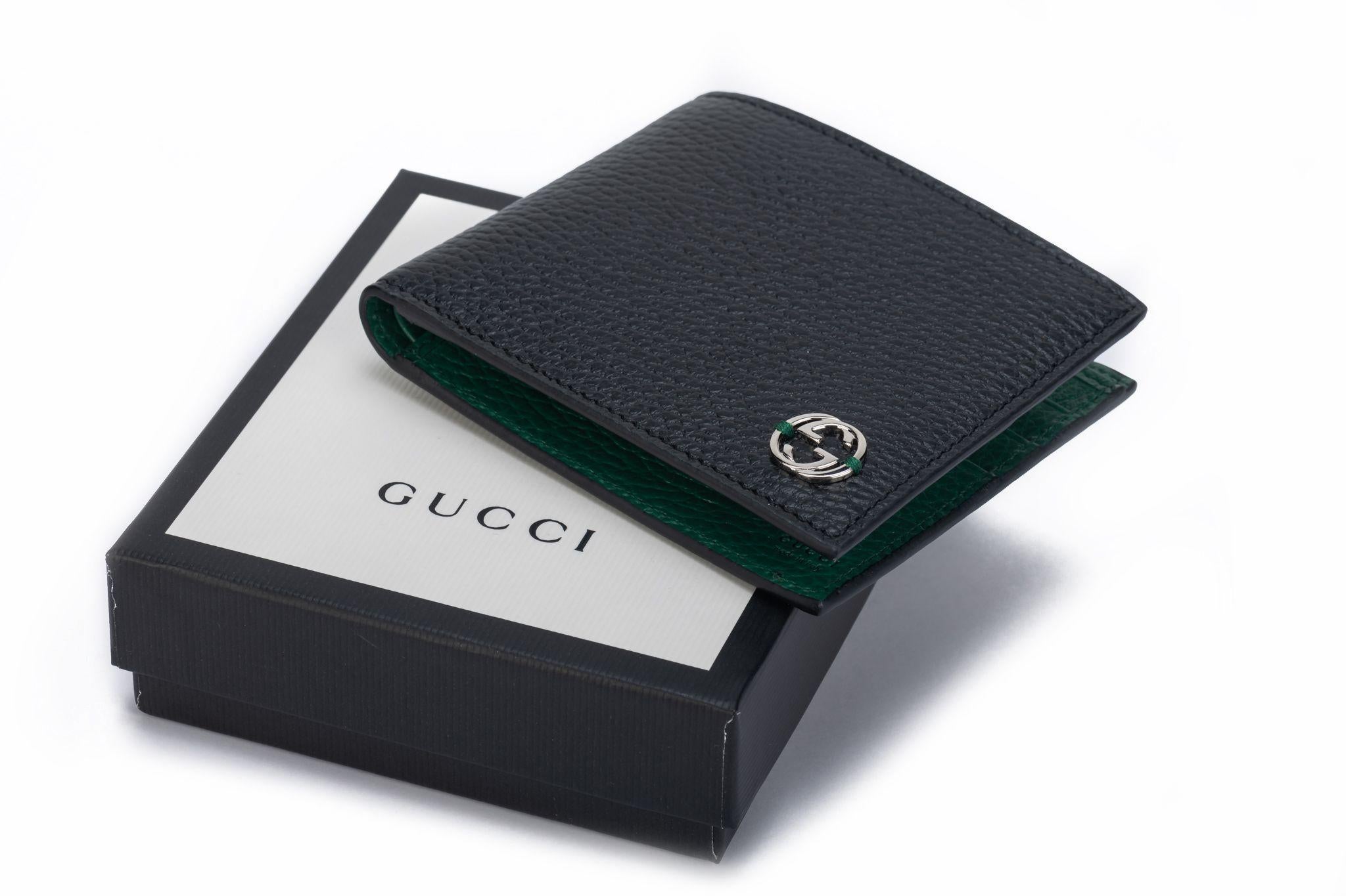 Gucci new black leather bifold wallet with green interior and silver tone logo. Comes with original dust cover and box.