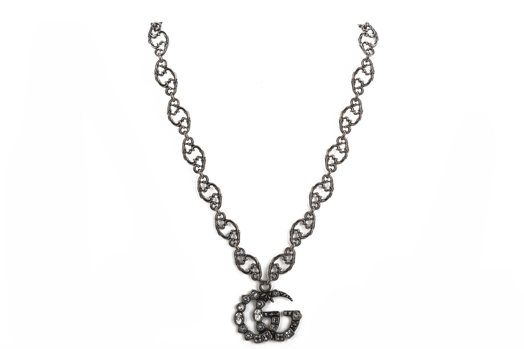 Gucci new gunmetal necklace with crystal GG logo pendant. Original price $890. Comes with original box.