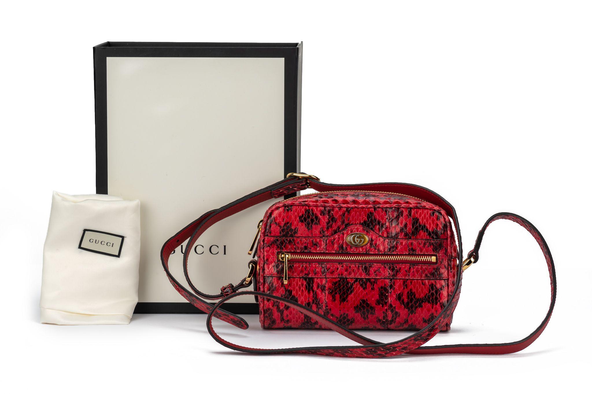 New GUCCI crossbody watersnake bag in red. The piece comes with an adjustable shoulder strap which measures 22.5 inches. Also it comes with the original box and dustcover.