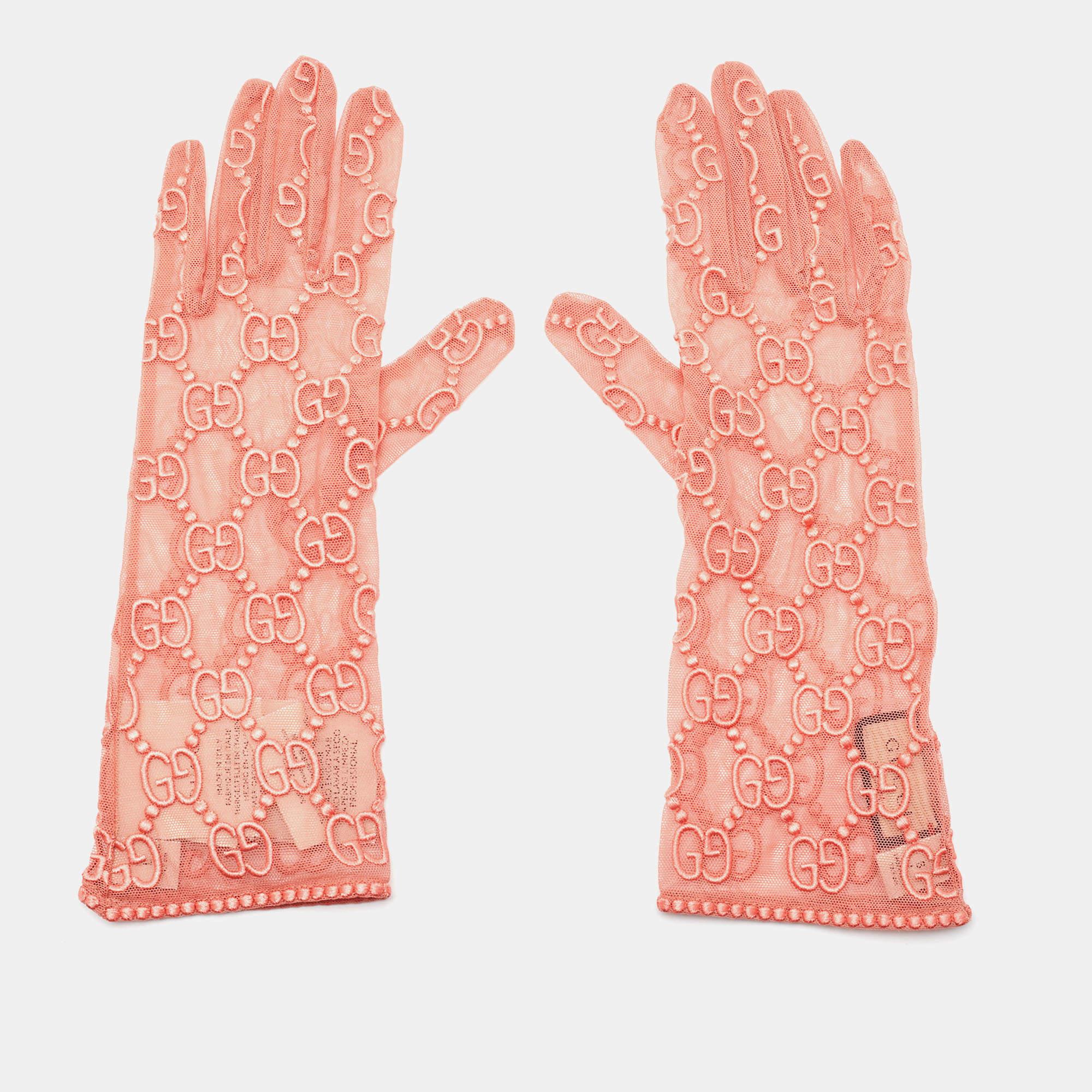 The Gucci gloves are a chic accessory. Crafted from delicate pink tulle, they feature Gucci's iconic logo embroidery, creating a sophisticated and stylish design. These gloves add a touch of elegance to any outfit, making them a perfect choice for