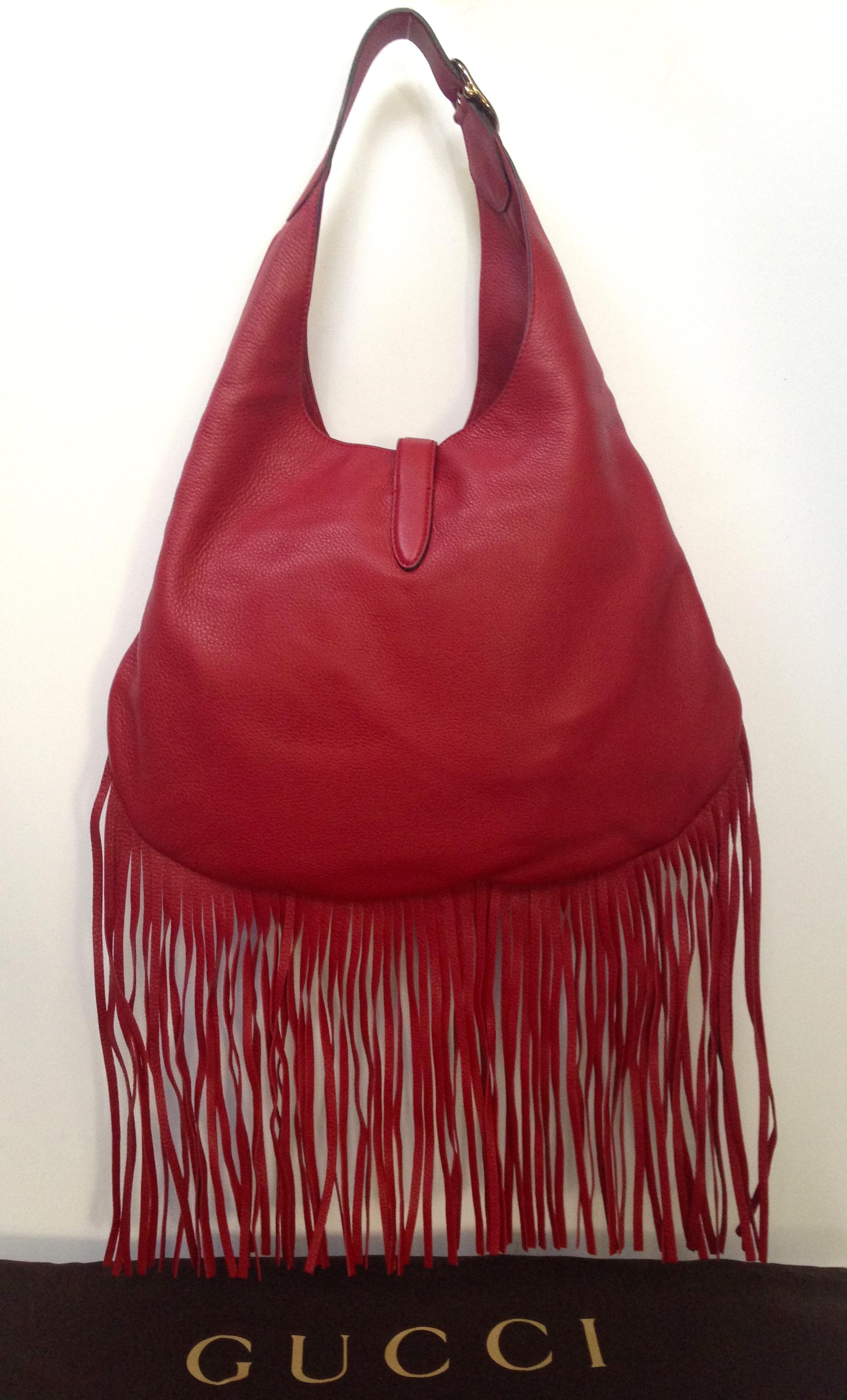 Gucci Nouveau fringe leather hobo handbag.  Red leather with silver piston closure and adjustable buckled shoulder strap with 9