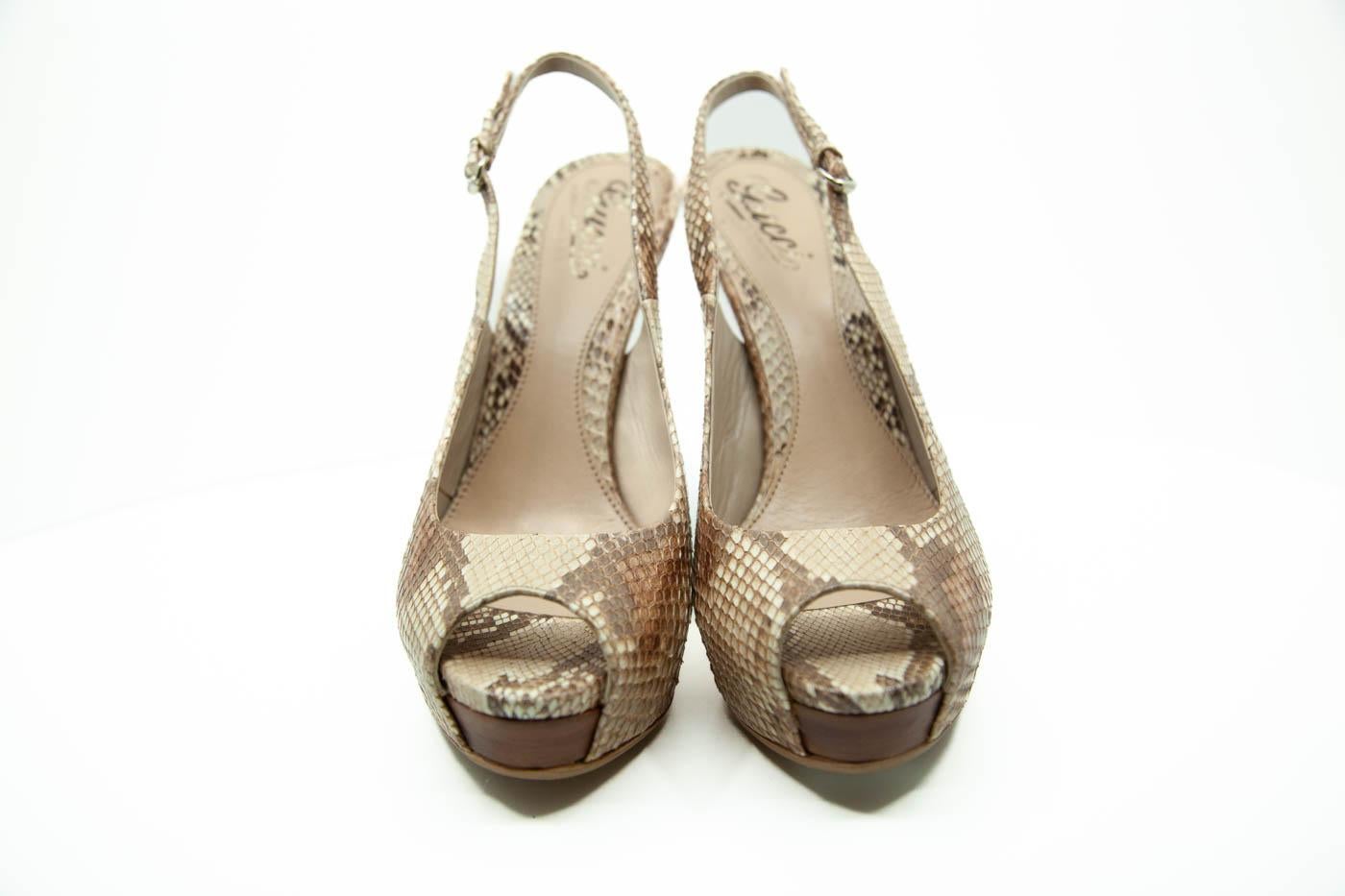 Gucci nude and brown python skin platform pumps, peep toes, platforms, leather insoles, slingback straps with silver tone buckle closures and 5.5