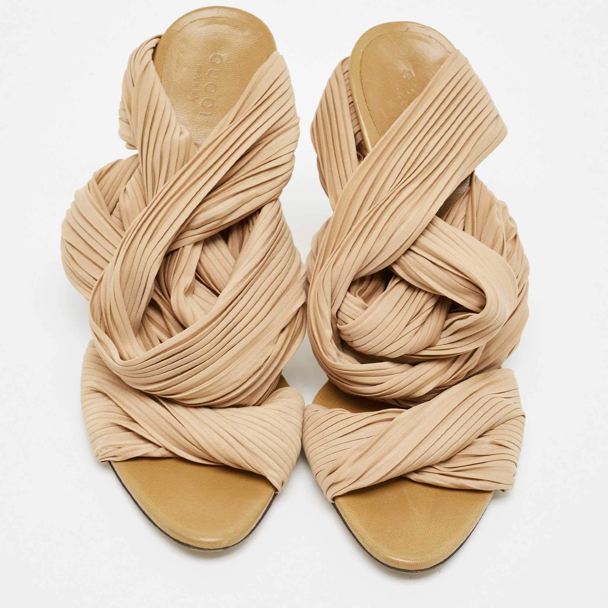 How splendid are these sandals from Gucci! They come designed with dual straps made from stretch pleated fabric and a soft nude shade which just adds to the beauty of the pair. The slides carry leather insoles and a set of 11cm heels.

