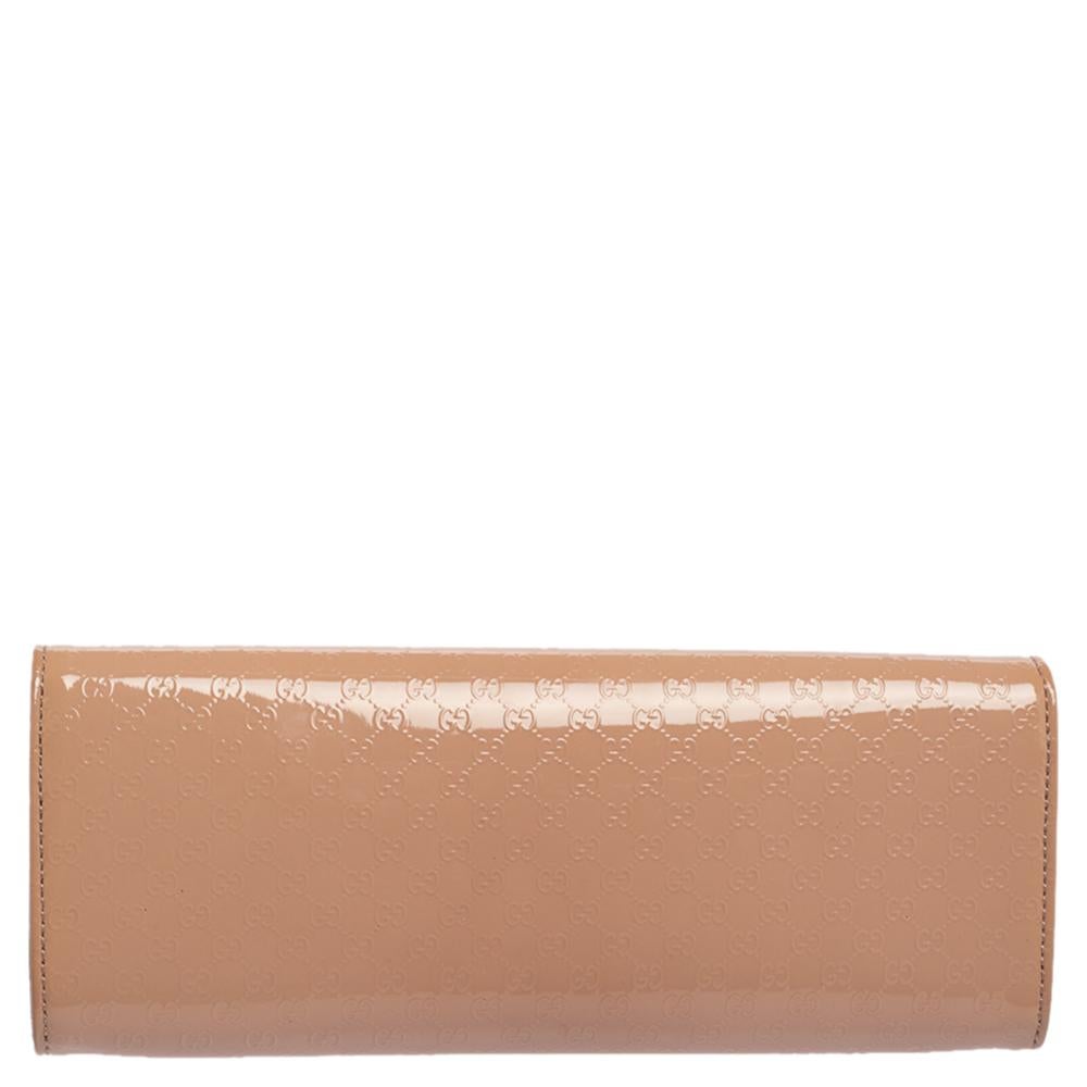 A must-have for all Gucci lovers! This nude Broadway clutch is crafted from patent leather and laid with Microguccissima embossing. The flap closure with concealed magnetic fastening secures its leather & suede-lined interior.

Includes: Original