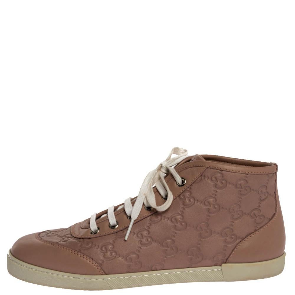 Stacked with signature details, this Gucci pair is rendered in Guccissima leather and is designed in a high-top style with lace-up vamps. They have been designed to carry a lovely nude pink hue. Complete with the brand label on the heels, these