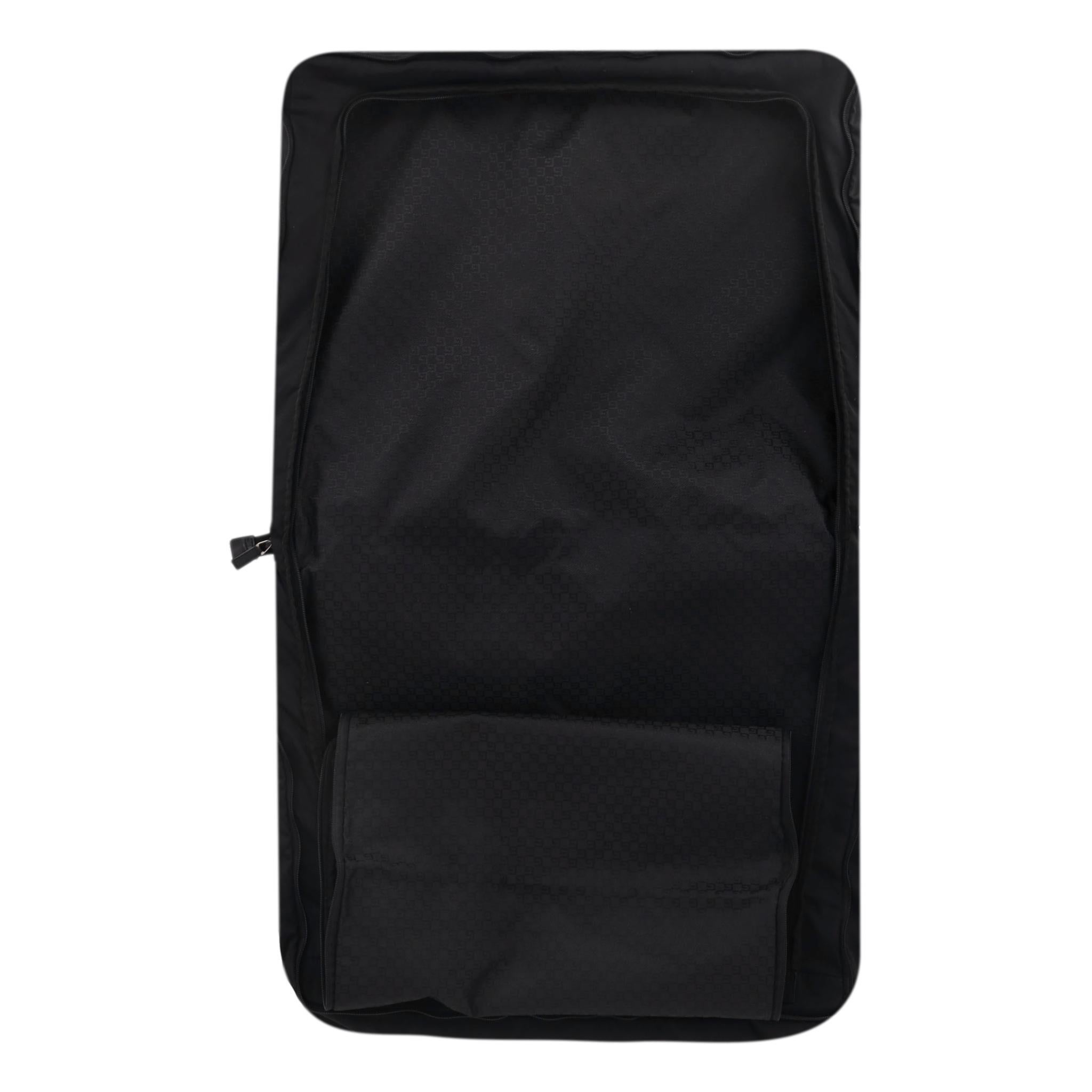 Gucci Nylon Soft Garment Luggage Bag

Black garment bag with 'Gucci' engraved silver plaque to the front and leather trim.

Folded design with zip-around closure leading to two spacious, interior pockets.

The main compartment is designed to keep