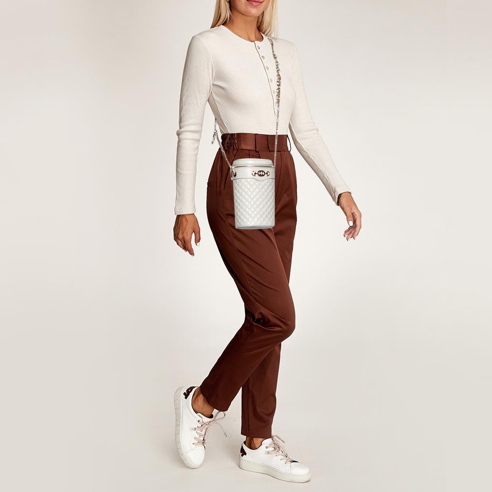 Constructed using quilted leather in a cylindrical shape, this Gucci Trapuntata bag delivers a chic-casual vibe. It has a signature symbol on the front and a zip-top closure that secures the well-sized interior. Carry it with the shoulder