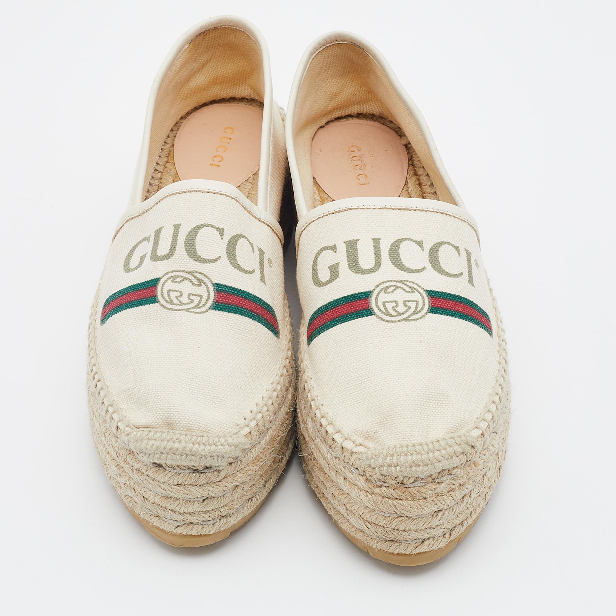 Step out in style and make others go gaga over these chic espadrilles from Gucci! These beige espadrilles are crafted from canvas and leather trims and feature round toes. They have been detailed with a vintage brand logo and the signature web print