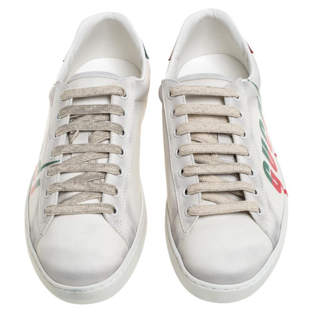 Stacked with signature details, this Gucci pair is rendered in distressed leather and is designed in a low-cut style with lace-up vamps. The off white sneakers have been fashioned with the brand logo in a blade print on the sides. Complete with red