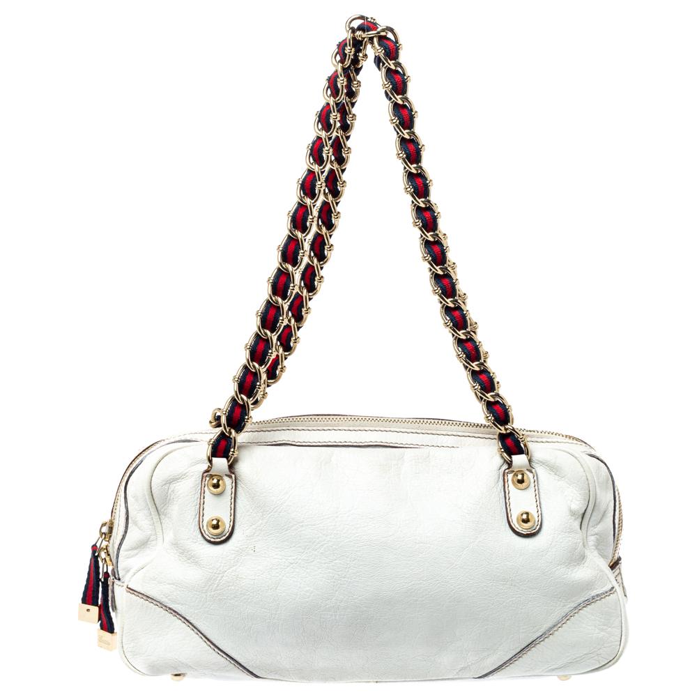 This Capri bowler bag from Gucci is what your wardrobe has been missing all this while! The bag is crafted from leather and features a chic silhouette. It flaunts dual zip pockets on the front and is twin handles. It has a top zip closure that opens