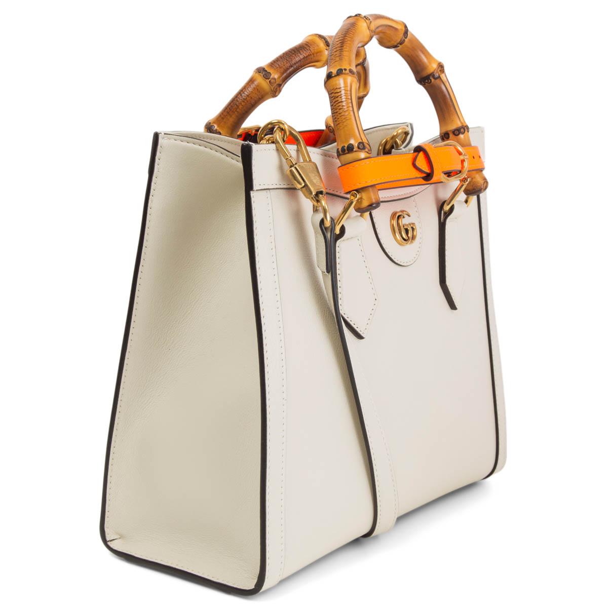100% authentic Gucci Diana Small Tote Bag in ecru calfskin, combining recognizable elements of the House, the small tote bag is defined by its bamboo handles and gold-tone Double G hardware. The bag is further accentuated by two orange neon straps,