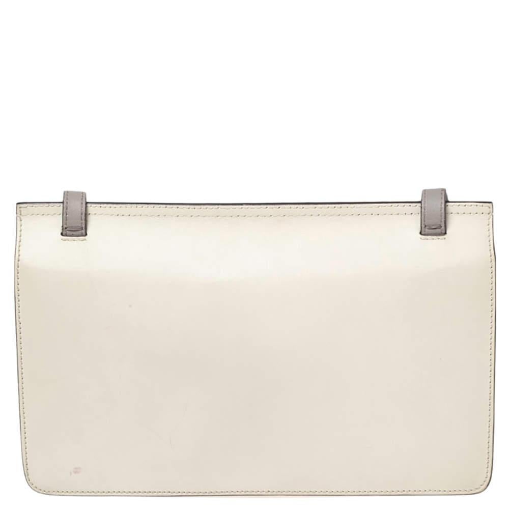 Crafted using off-white leather, this fabulous Gucci bag has a front flap detailed with the signature bamboo motif. A leather strap and dual interior compartments complete this Lady Bamboo bag.

