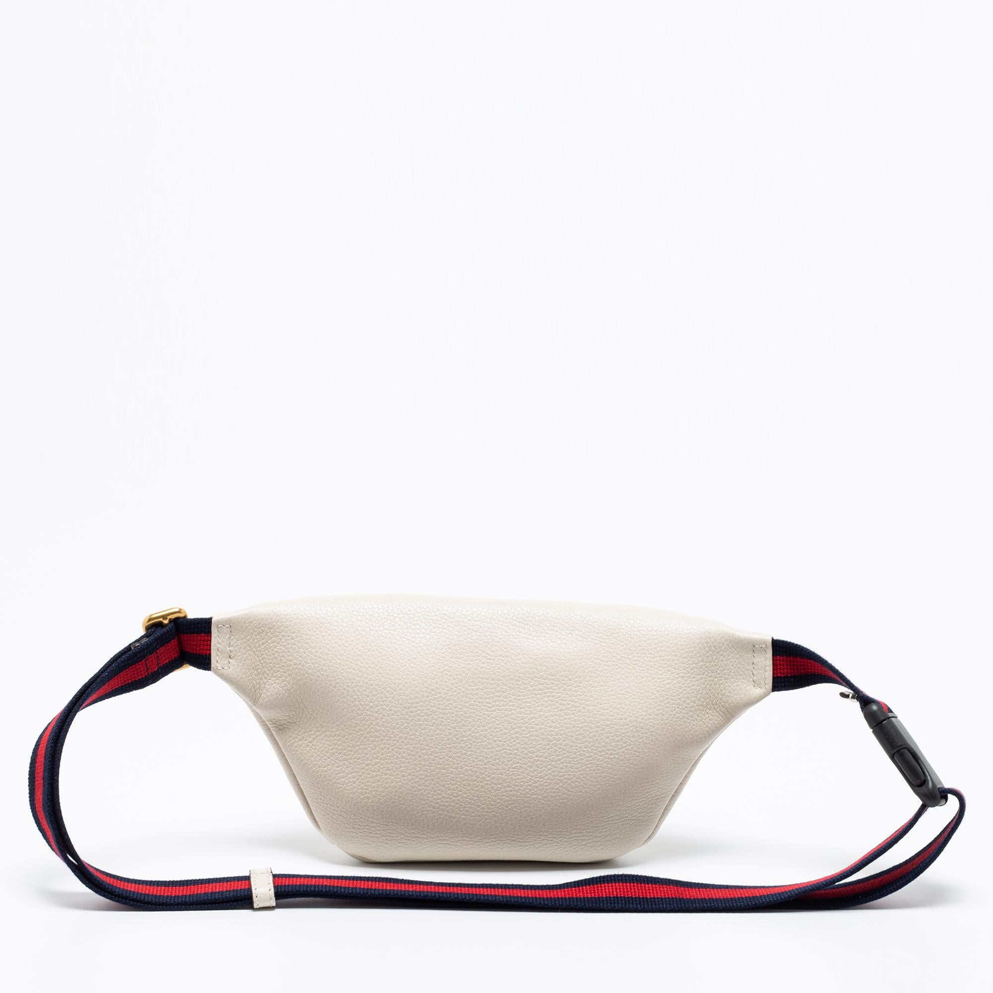Elevated with traditional elements, this Gucci belt bag strikes the perfect balance between fashion and function. Crafted from leather, the brand detailing on the front and the Web stripe detailed waist belt offer it a statement appeal. The