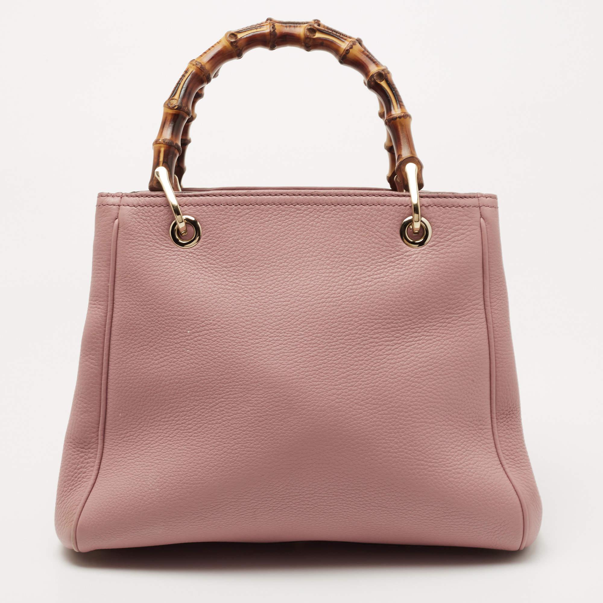 Gucci's luxe aesthetic and artistic inspiration comes from its rich history. And this stunning tote is a true example of that! The iconic Bamboo motif handles are perched atop this structured tote, perfectly completing its old rose exterior. Fitted