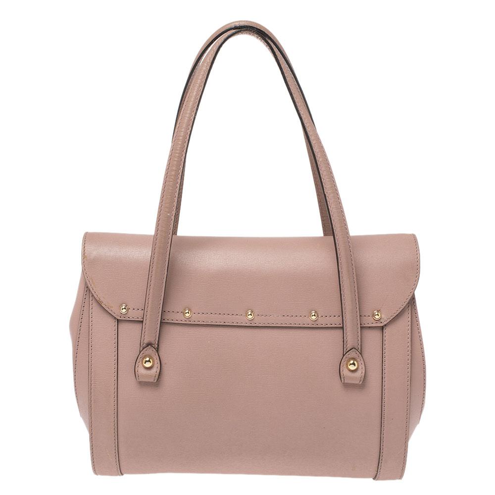 Bags from Gucci are on every woman's wishlist. So, own this gorgeous New Bullet bag today and light up your closet! Crafted from leather, this stunning pink number has a front flap that is detailed with the signature bamboo motif and opens to a