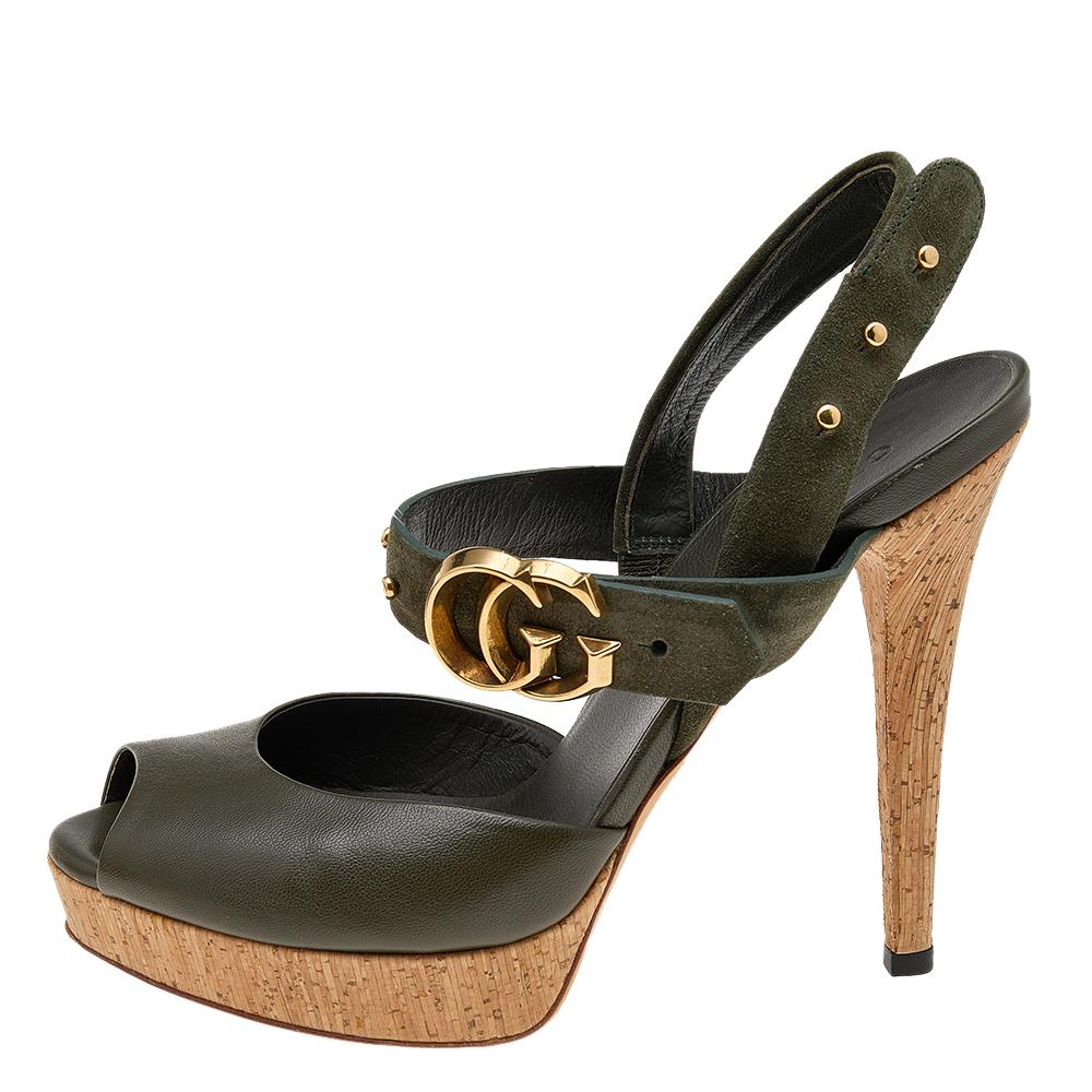 Enter the room stylishly in these olive green Gucci sandals. They have been made from leather and suede and flaunt complementing gold-tone hardware. They have an ankle-strap design and are supported on lovely cork platforms and 12.5 cm