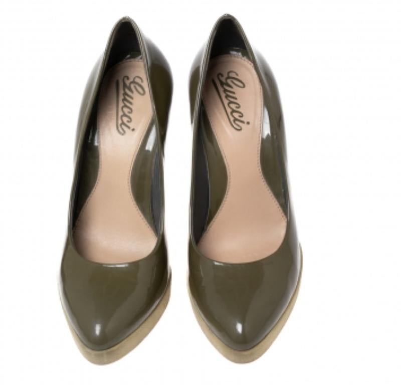 These olive green pumps from Gucci are a smart pick for everyday use or for a special occasion. They are crafted from patent leather and feature stylish platforms. They are equipped with comfortable leather-lined insoles and elevated on 12 cm heels.