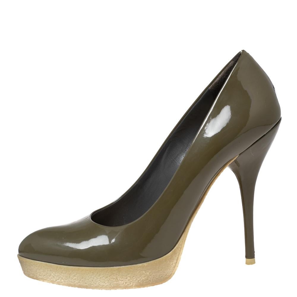These olive green pumps from Gucci are a smart pick for everyday use or for a special occasion. They are crafted from patent leather and feature stylish platforms. They are equipped with comfortable leather-lined insoles and elevated on 12 cm heels.