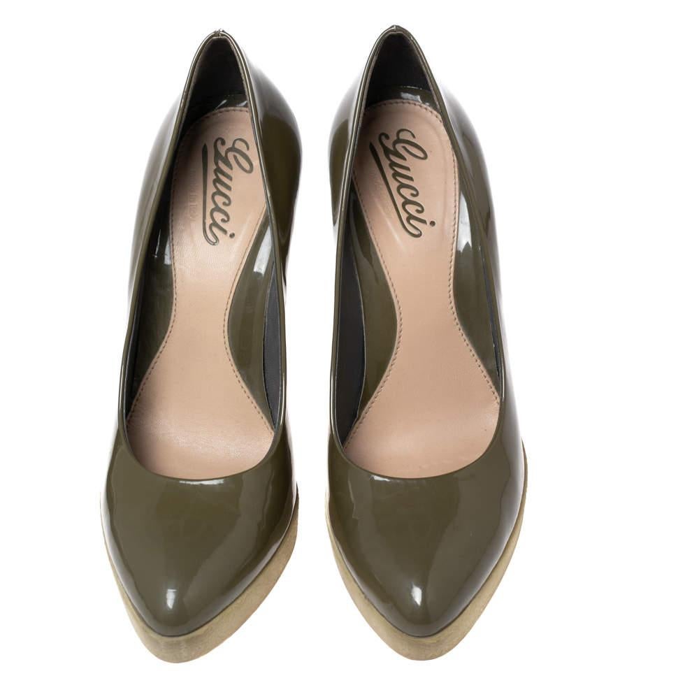 These olive green pumps from Gucci are a smart pick for everyday use or for a special occasion. They are crafted from patent leather and feature stylish platforms. They are equipped with comfortable leather-lined insoles and elevated on 12 cm