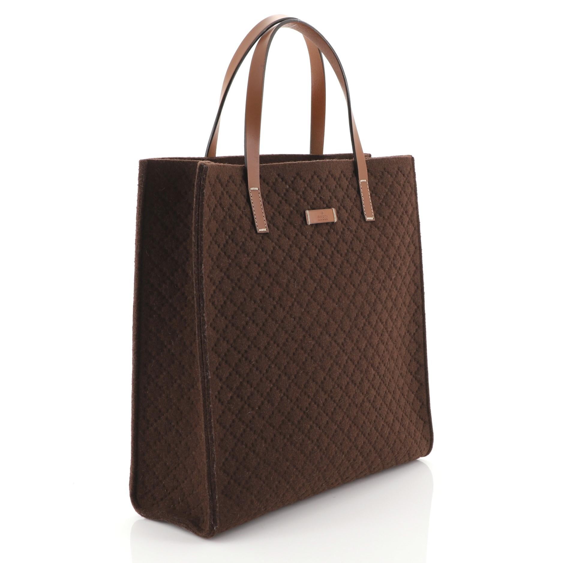 This Gucci Open Tote Diamante Wool Tall, crafted from brown diamante wool, features dual leather handles and silver-tone hardware. It opens to a brown wool interior. 

Estimated Retail Price: $1,200
Condition: Excellent. Minor wear on exterior and