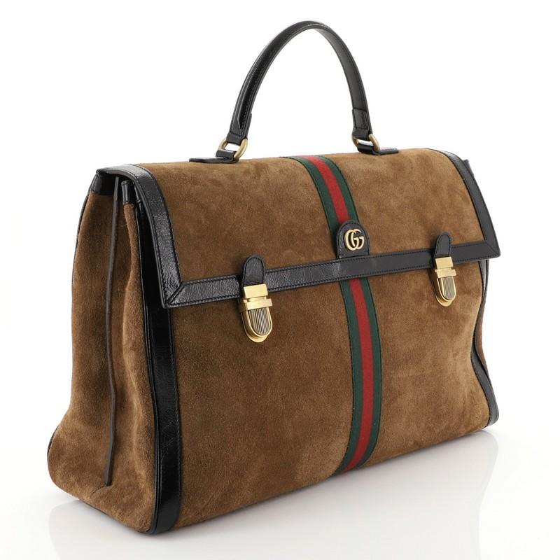 This Gucci Ophidia Briefcase Suede, crafted in brown suede, features leather top handle, web stripe detail, leather trim, and aged gold-tone hardware. Its flap with dual push-lock closure opens to a brown suede interior divided into two compartments