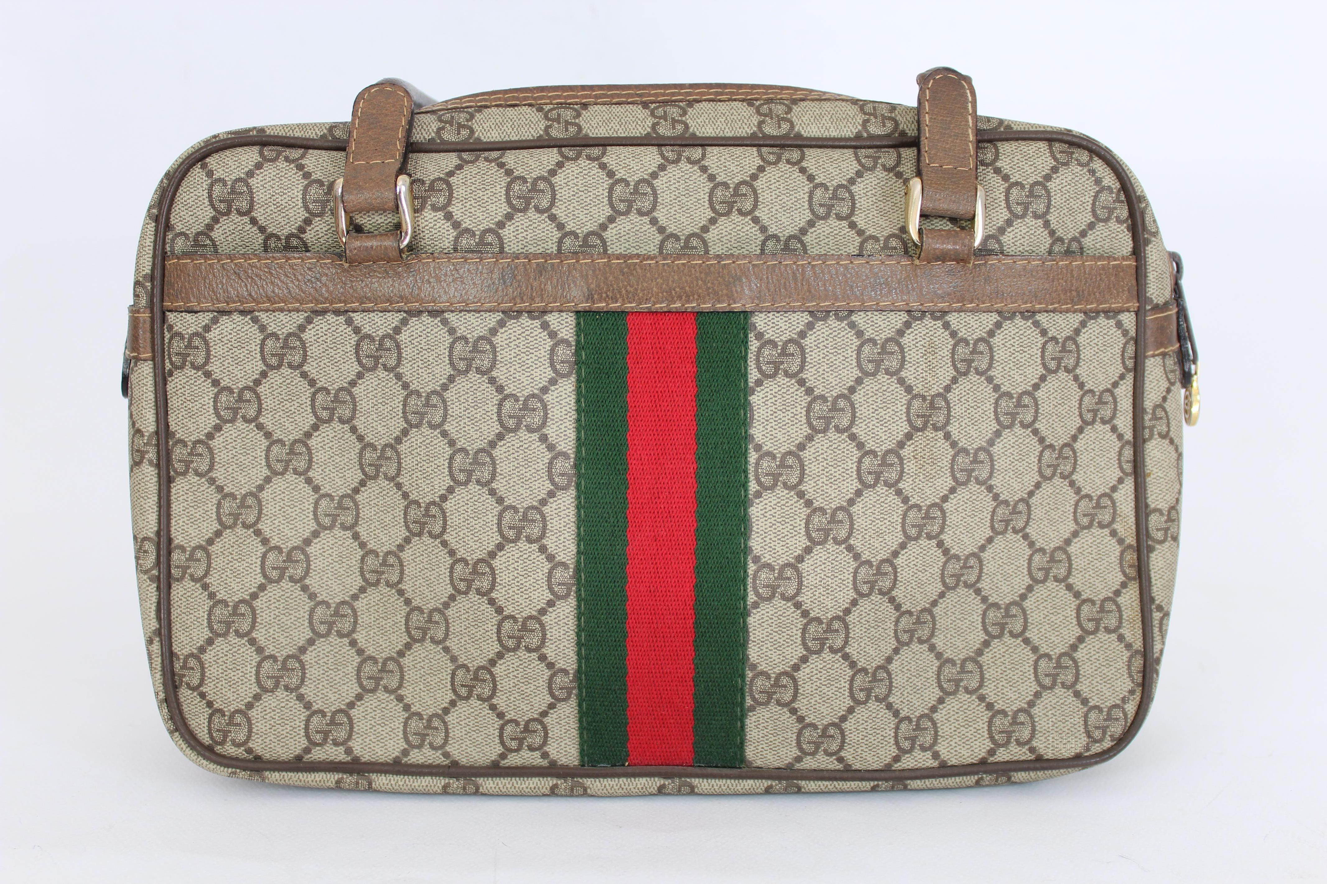 Gucci Ophidia vintage bag 80s. Handbag type satchel, brown and beige with green and red bands. Gold-colored details, both internal and external pockets. Canvas fabric with leather handles and edges. Made in Italy. The overall condition of the bag is