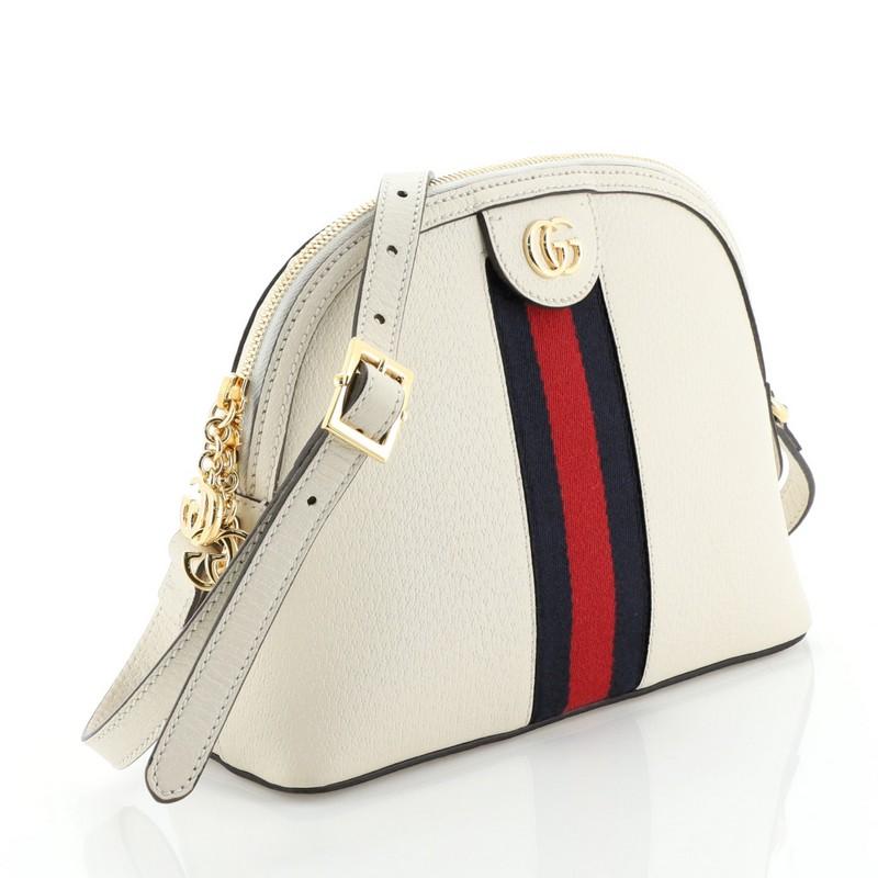 This Gucci Ophidia Dome Shoulder Bag Leather Small, crafted in neutral leather, features an adjustable leather strap, web striped design, and gold-tone hardware. Its zip closure opens to a neutral microfiber interior. 

Condition: Great. Wear on