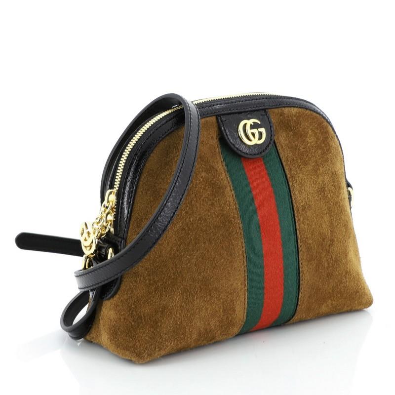 This Gucci Ophidia Dome Shoulder Bag Suede Small, crafted in brown suede, features inlaid web stripe detail, leather shoulder strap, and gold-tone hardware. Its zip closure opens to a blue satin interior with side slip pockets. 

Estimated Retail