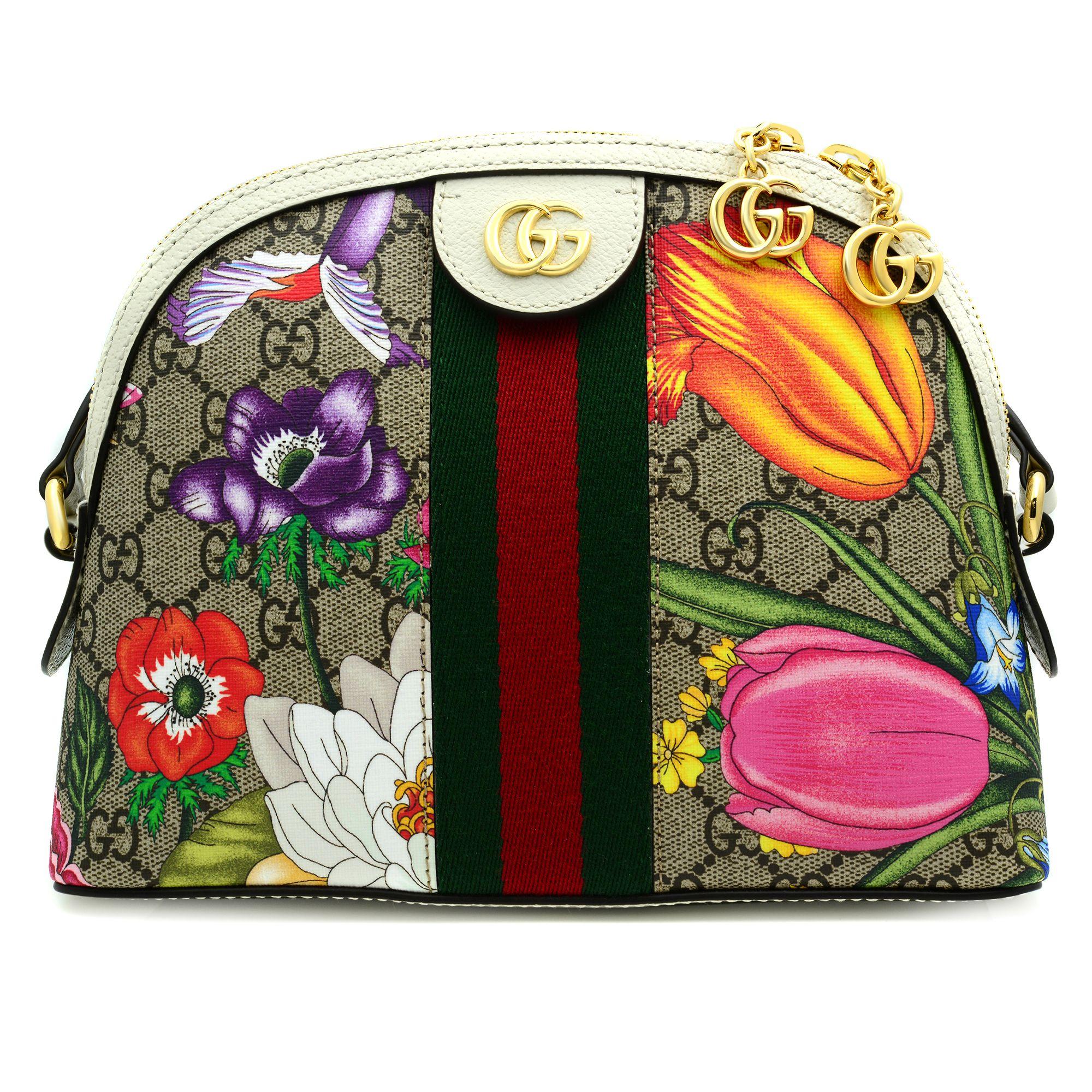 This Gucci bag is crafted from beige/ebony GG Supreme canvas with white leather trim. The features a zipper closure, flora print, green and red Web detail, zipper pullers with Double G charms, adjustable shoulder strap with 17.5
