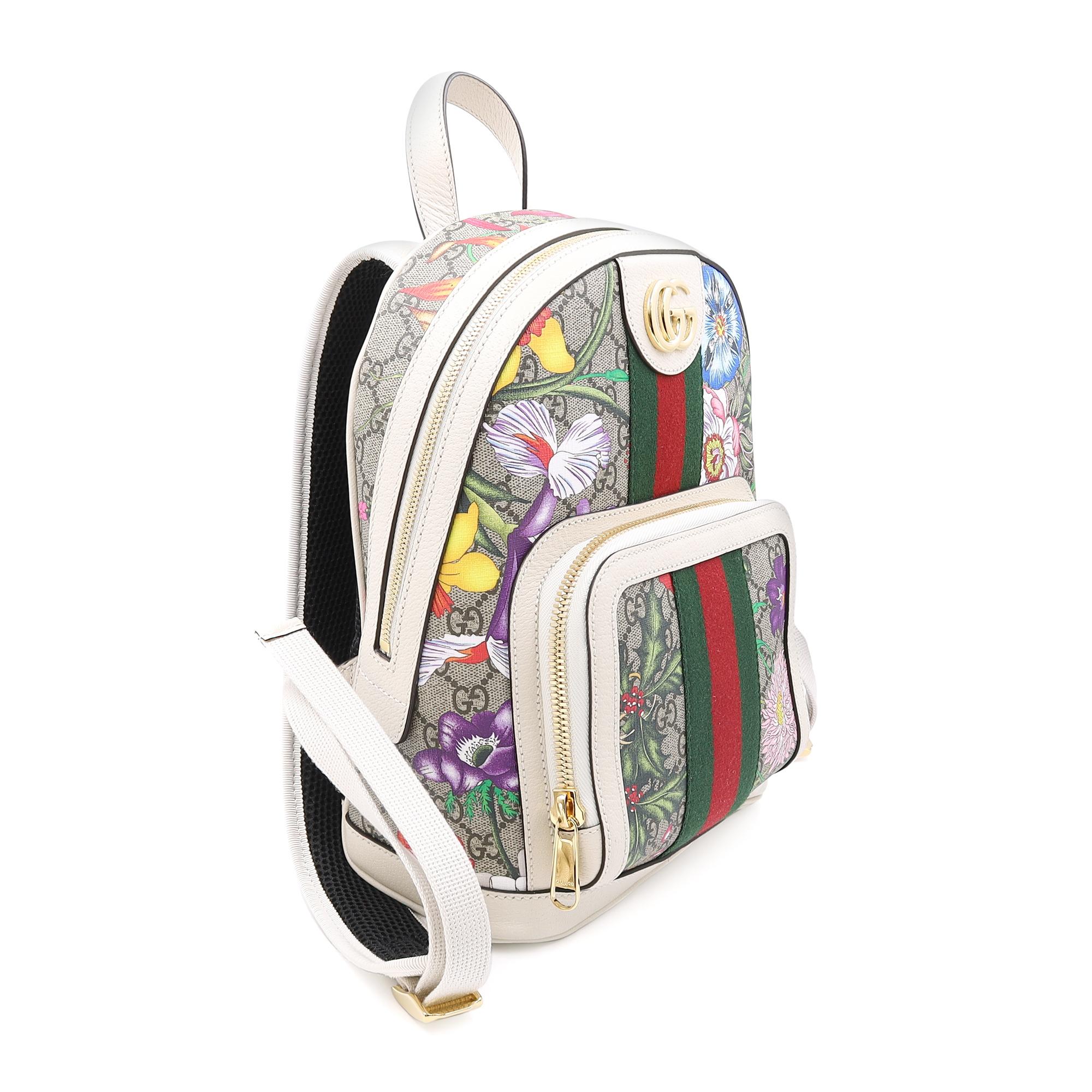 Gucci Ophidia small white ladies backpack featuring GG supreme canvas with multicolor floral motifs and double GG gold tone logo hardware on the front. Comes with a small front zip pocket and main zip around compartment with multiple interior card